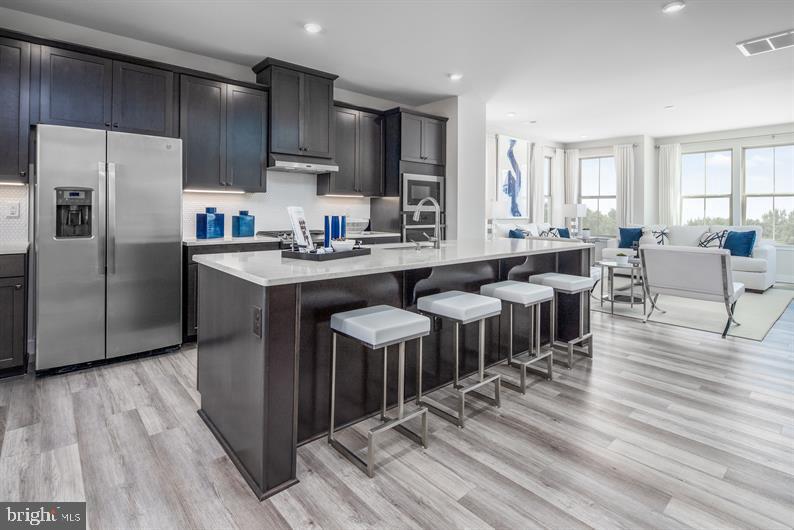 MOVE-IN READY!!! THE COMMUNITY LOCATION YOU HAVE BEEN WAITING FOR IN HOWARD COUNTY. *** FOR A LIMITED TIME, TAKE ADVANTAGE OF OUR $15,000 FLEX DOLLARS
INCENTIVE ***
The largest of Ryan’s Composer Series, the Strauss offers the space and customizing details of single-family living with the convenience of a townhome. On the main living level, an enormous Kitchen with upgraded cabinets, under cabinet lighting, and backsplash. The island opens onto a bright and airy Living Room, perfect for entertaining. A window-lined Morning Room off the Kitchen provides room for dining and is accented with an optional hutch. Up a flight of stairs designed to be elegant and functional, the upper level boasts three bedrooms, two baths, and a 2nd floor laundry. No need to worry about storage space – generous closets abound in all bedrooms. The Primary Bedroom is a private retreat accented with a tray ceiling and featuring an enormous walk-in closet. The Primary Bath boasts a soaking tub and separate shower with seat. Several lower level floor plan options are available depending on community– all feature options for a finished Recreation Room, 4th bedroom, and Powder Room.