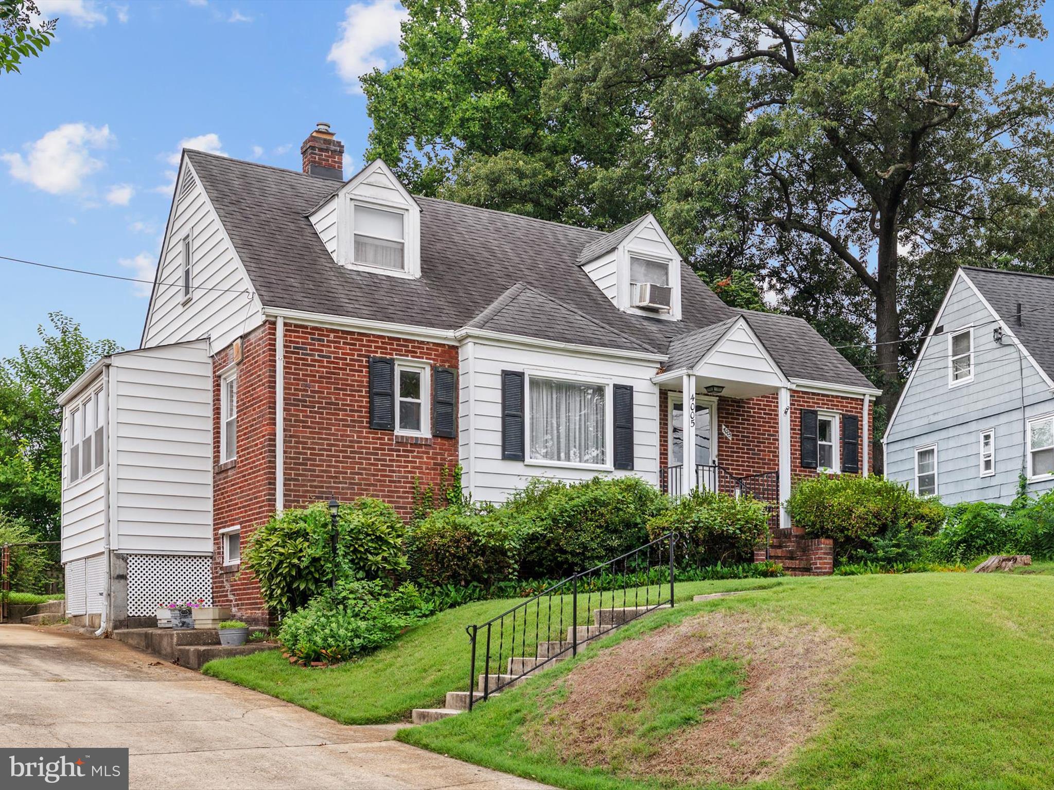 Move-in ready and full of character, 4005 Quintana Street reflects true pride of ownership inside and out. Located in Ward 2 of the City of Hyattsville, this classic Cape Cod sits elevated above the street on a lovely landscaped lot with a level and fully fenced backyard — ideal for gardening, play, or outdoor evenings. The main level offers a warm and welcoming layout with a bright Living Room, separate Dining Room, and an updated Kitchen. Just off the Kitchen, an enclosed Breezeway leads to the backyard for seamless indoor-outdoor flow. Two Bedrooms and a full Bath round out the main level, with hardwood floors beneath the carpet. Upstairs, the third Bedroom offers flexible space perfect for a home office, guest room, or creative studio. The lower level includes a cozy Rec Room with vintage knotty pine paneling, a half Bath (plumbed for a shower), laundry and utility areas, and plenty of storage. Conveniently located near local spots, public transportation, schools, and parks, this home offers the a blend of charm and convenience.
