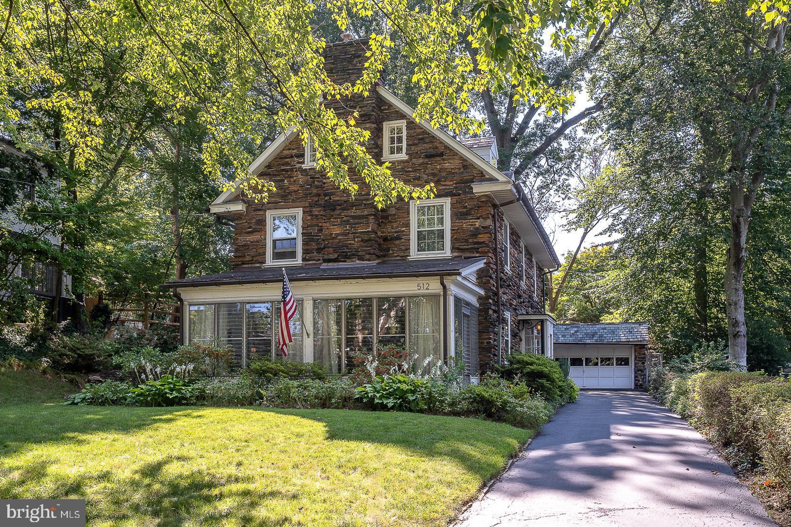 Classic Stone Colonial on Sought-After Street
Welcome to 512 Anthwyn Road, a beautifully maintained classic stone Colonial home located in the heart of Merion Station, PA. This charming residence offers an exquisite blend of timeless elegance and modern conveniences across its almost 2500 square feet of living space.
As you approach, the unique stone exterior and slate roof immediately capture your attention, radiating a sense of durability and classic style. Enter through an enclosed vestibule into a lovely center hall, where you'll find deep window sills and gleaming hardwood floors that set a welcoming tone.
The spacious living room, featuring a wood-burning fireplace, provides a cozy yet grand space perfect for relaxation or entertaining. A door leads out to a bright enclosed porch with flagstone flooring, a stone wall, and three walls of windows, creating an inviting space to enjoy the outdoors in comfort.
Adjacent to the living room, the formal dining room offers an elegant setting for meals and gatherings. Beyond the dining room, a functional kitchen awaits, complete with an adjoining mudroom and a walk-in pantry, ensuring ample storage and convenience.
Ascend the gracious staircase, accented by an arched window, to the second floor. The primary bedroom is a serene retreat, featuring a walk-in closet and a full bath with a stall shower. Two additional well-sized bedrooms share an updated hall bath with ceramic tile, providing comfort and privacy.
The open staircase continues to the finished third floor, where you'll find two more bedrooms and an additional full bath, perfect for guests or flexible living arrangements.
The unfinished basement includes a laundry area and a large room with wood flooring, offering potential for additional living space or storage. Mature plantings surround the home, enhancing its curb appeal and providing a tranquil setting.
Completing this remarkable property is a detached two-car garage with stairs leading up to a private fenced-in yard area, ideal for outdoor activities and relaxation.
This home is in wonderful condition and enjoys a terrific location, with the added bonus of being able to walk to downtown Narberth. Experience the perfect blend of classic charm and modern living at 512 Anthwyn Road. Don't miss the opportunity to make this exceptional property your new home!