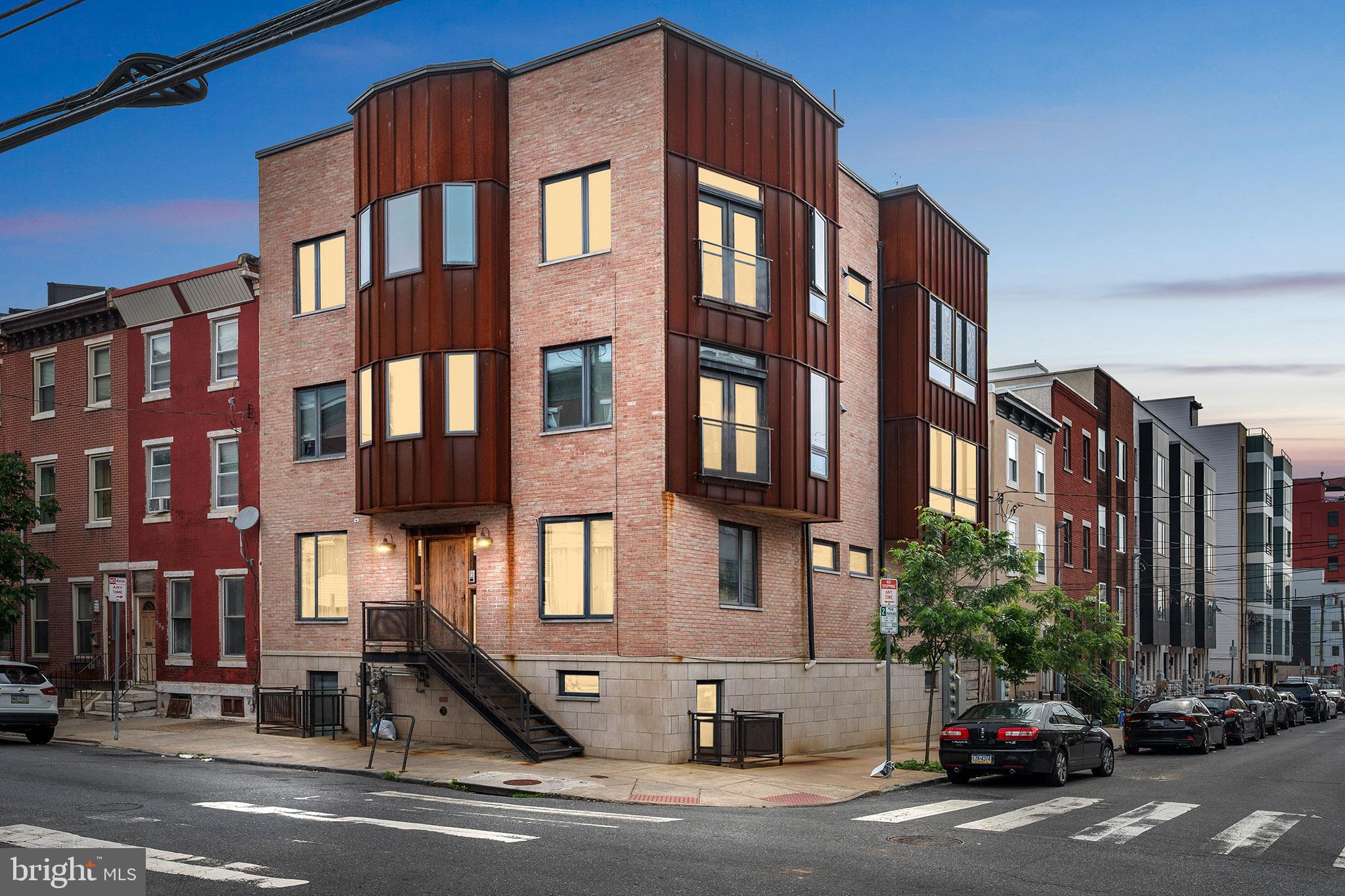 Welcome to this thoughtfully designed 2-bedroom, 2-bathroom bi-level condo offering over 1,200 square feet of modern living in the vibrant Francisville neighborhood—just steps from Fairmount Ave and Ridge Ave’s dynamic restaurant and retail scene. The main level features an open-concept living area with custom metal railings, hardwood floors, and a chef’s kitchen appointed with quartz countertops, stainless steel appliances, and a handcrafted reclaimed wood dining table—included with the sale. Downstairs, you'll find two well-sized bedrooms positioned on opposite ends for added privacy, along with two full baths, a utility/laundry room, and generous storage. The private rear patio offers a quiet escape—perfect for morning coffee or evening gatherings. Purchase this prime real estate in one of Philly's most dynamic locations today.