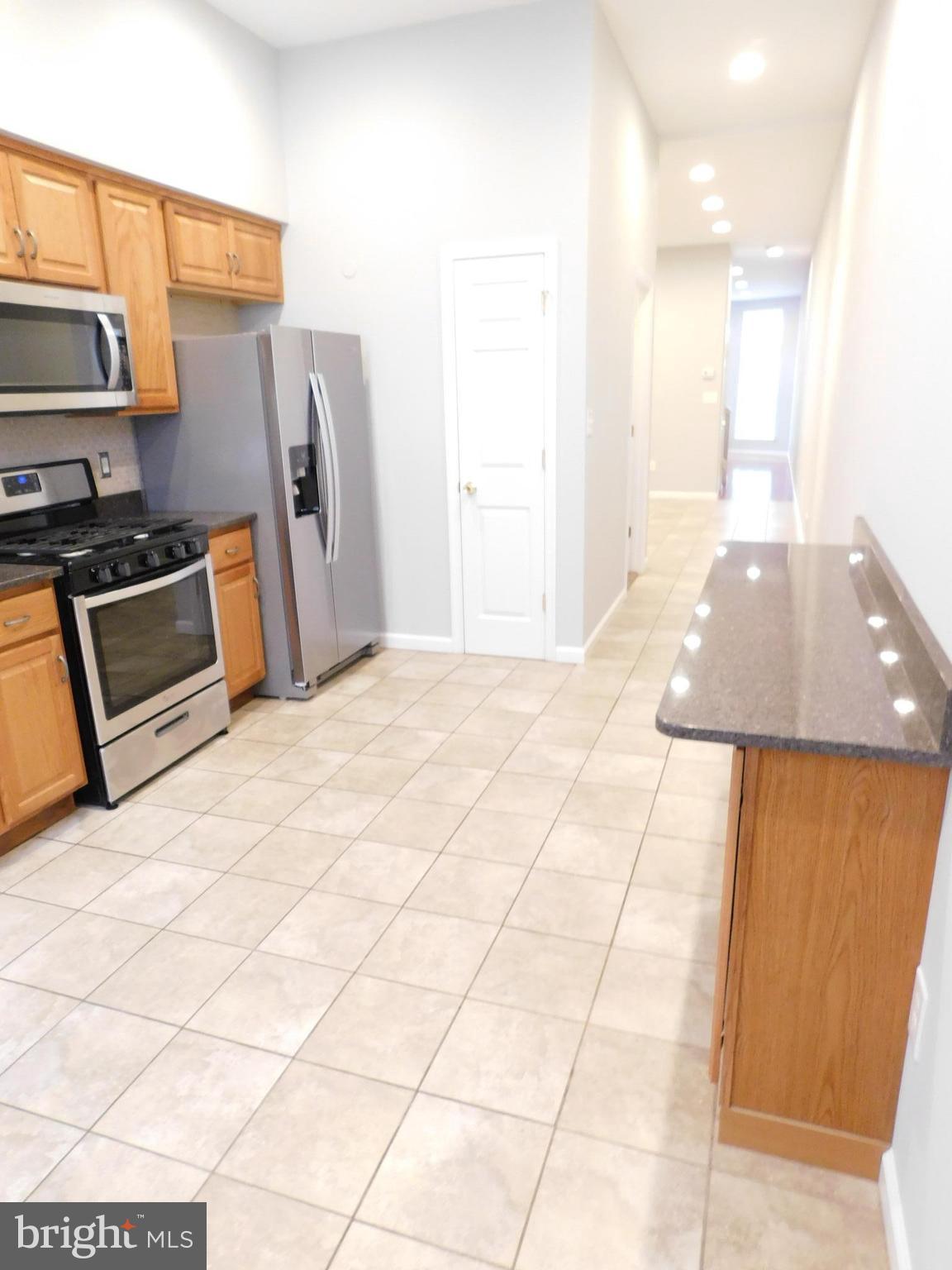 When this 5 bedrm 2.5 bath beauty was renovated, "EVERYTHING" on the inside was made new. New granite countertops. New package of stainless steel appliances. Gorgeous ceramic tilework. Gorgeous wood floors in living rm, hallways, & stairways. Deck. New carpet & paint. Recessed lighting almost everywhere. High amp electric system, modern overhaul of the supply & drain lines, 2 zone heat & air.