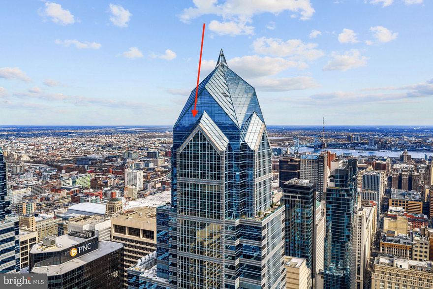 Perched high above Center City on the 56th floor of the iconic Two Liberty Place, this extraordinary penthouse delivers a rare opportunity to own one of Philadelphia’s most breathtaking residences. One of only four homes on this exclusive level, the residence was thoughtfully designed with elevated architectural detail and refined luxury throughout.

Soaring nearly 11 feet high, dramatic convex and concave floor to ceiling windows create a true in the sky experience, framing sweeping panoramic views of both the Schuylkill River and Delaware River. From the primary suite, the neighboring One Liberty Place becomes a striking architectural backdrop unlike anything else in the city. Morning sunrises and evening sunsets paint the skyline in every direction, offering a perspective few will ever experience.

Designed for both comfort and entertaining, the expansive open concept great room is anchored by a statement curved glass wall and gas fireplace, creating a natural separation between the luxurious primary suite and the flexible guest bedroom or private den.

The chef’s kitchen blends sleek European design with high performance function, featuring premium Miele appliances, a Sub-Zero refrigerator, wine cooler, and elegant Italian Snaidero cabinetry.

The primary suite is wrapped in dramatic glass panels and complemented by a custom dressing area and oversized walk in closet. The spa inspired bath is finished in warm grey and white marble and includes a soaking tub, glass enclosed shower, and dual vanities. The spacious second bedroom or den offers its own marble bath and generous closet space.

A marble powder room and separate laundry area are discreetly positioned for everyday convenience.

Residents of Two Liberty Place enjoy a full suite of luxury amenities, including 24 hour doorman and security, valet and self parking with unlimited guest access, private storage, and direct access to the Shops at Liberty Place. The newly renovated 37th floor amenity level, completed in March 2024, features a state of the art fitness center, indoor pool, massage room, yoga studio, sauna, steam room, business center, multiple boardrooms, and an expansive residents lounge with sweeping city views. An additional third floor amenity space offers breakfast through lunch service from 7:30 AM to 3:30 PM exclusively for residents and building employees.

Originally showcased as the developer’s model residence and meticulously maintained, this exceptional penthouse is offered unfurnished, with furnishings negotiable.

Iconic views. Elevated privacy. Unmatched Philadelphia living.