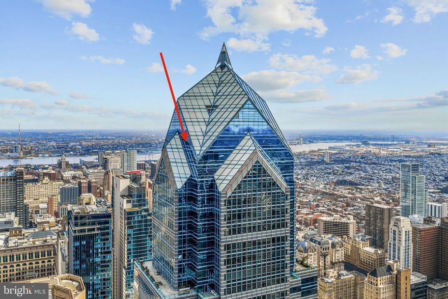 Perched high above Center City on the 56th floor of the iconic Two Liberty Place, this extraordinary penthouse delivers a rare opportunity to own one of Philadelphia’s most breathtaking residences. One of only four homes on this exclusive level, the residence was thoughtfully designed with elevated architectural detail and refined luxury throughout.

Soaring nearly 11 feet high, dramatic convex and concave floor to ceiling windows create a true in the sky experience, framing sweeping panoramic views of both the Schuylkill River and Delaware River. From the primary suite, the neighboring One Liberty Place becomes a striking architectural backdrop unlike anything else in the city. Morning sunrises and evening sunsets paint the skyline in every direction, offering a perspective few will ever experience.

Designed for both comfort and entertaining, the expansive open concept great room is anchored by a statement curved glass wall and gas fireplace, creating a natural separation between the luxurious primary suite and the flexible guest bedroom or private den.

The chef’s kitchen blends sleek European design with high performance function, featuring premium Miele appliances, a Sub-Zero refrigerator, wine cooler, and elegant Italian Snaidero cabinetry.

The primary suite is wrapped in dramatic glass panels and complemented by a custom dressing area and oversized walk in closet. The spa inspired bath is finished in warm grey and white marble and includes a soaking tub, glass enclosed shower, and dual vanities. The spacious second bedroom or den offers its own marble bath and generous closet space.

A marble powder room and separate laundry area are discreetly positioned for everyday convenience.

Residents of Two Liberty Place enjoy a full suite of luxury amenities, including 24 hour doorman and security, valet and self parking with unlimited guest access, private storage, and direct access to the Shops at Liberty Place. The newly renovated 37th floor amenity level, completed in March 2024, features a state of the art fitness center, indoor pool, massage room, yoga studio, sauna, steam room, business center, multiple boardrooms, and an expansive residents lounge with sweeping city views. An additional third floor amenity space offers breakfast through lunch service from 7:30 AM to 3:30 PM exclusively for residents and building employees.

Originally showcased as the developer’s model residence and meticulously maintained, this exceptional penthouse is offered unfurnished, with furnishings negotiable.

Iconic views. Elevated privacy. Unmatched Philadelphia living.