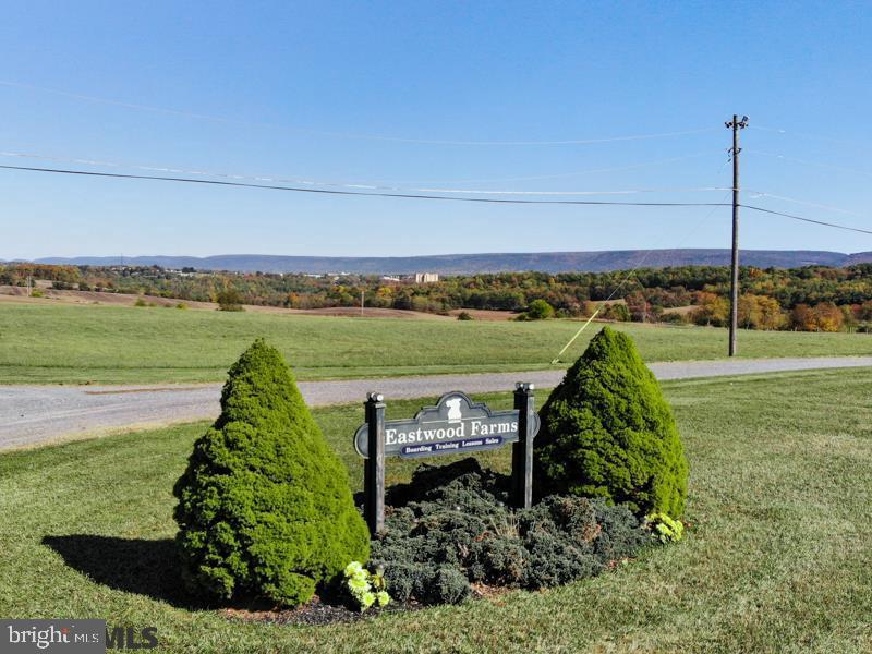 65+ Acre Horse Farm in a beautiful setting and ideal location minutes from State College & Penn State University with very easy access to the airport and I-80/I-99. Situated between Bellefonte and State College, this property is in a great location with respect to future growth in the Centre Region. 40 acres of productive hay fields allow for a self-sustaining horse operation. There are two barns with a total of 32 horse stalls. One has an attached 60X200 shadow-free riding ring, plus workshop and equipment storage and office space. There are two solid homes. One is a 1970 2-story, 3 bedroom, 2 bath home with a natural stone fireplace and an attached garage. The second home is a 2004 manufactured ranch with 3 beds + 2 baths with the potential for a separate apartment in the basement. Both homes have nice settings and views. There is a 200X400 exterior all-weather surface riding ring.