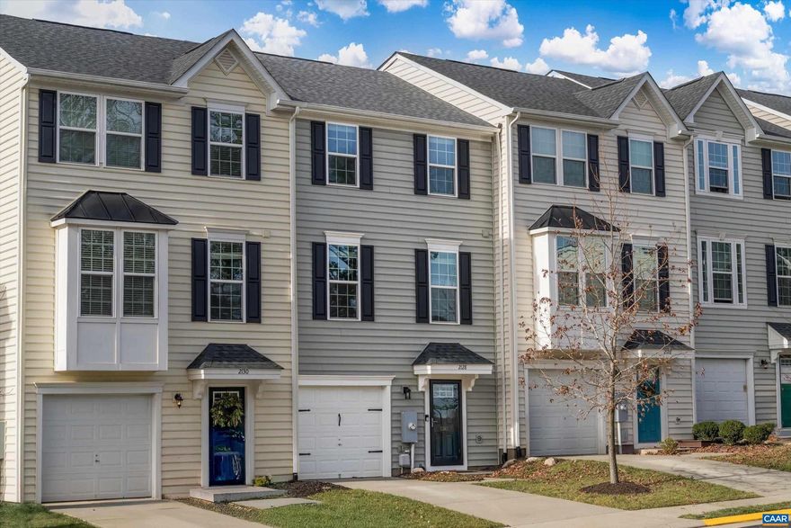 The main level has a spacious, open floor plan with a living room, kitchen, and dining area with high ceilings. The deck opens off the dining area and offers a nice view of the fenced backyard and open space beyond. The upper-level hall leads to the large primary bedroom suite, two additional bedrooms, a hall bath, and a laundry area.  The ground level has a family room and opens to the fenced backyard. One car garage.  Across the street you will find a playground, tree-lined common space, and visitor parking.   Located across from NGIC, near the airport and shopping and restaurants.  It takes 12 minutes to drive into Charlottesville.