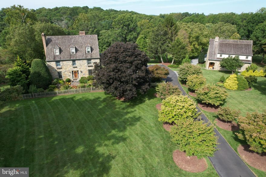 Step into your exclusive retreat! This exceptional property unveils a custom Gosnell-built residence sighted on 4.61 acres, accompanied by a meticulously crafted John duFief carriage house and an additional car barn on another 4.93 acres. Boasting two distinct parcels seamlessly integrated into a captivating family estate, this haven is thoughtfully designed with custom structures catering to the automotive enthusiast's dreams. Delight in embracing the professionally landscaped grounds, enchanting gardens, picturesque pool, rolling hills, and tranquil creek, creating a truly enjoyable setting!

Indulge in luxury living within the primary residence with an expansive 8,000 + sqft floor plan. This thoughtfully designed home features 6 bedrooms, 6 full baths and 2 half baths, and a well-connected kitchen, den, dining room, living room, beamed ceiling family room, and 2-story sunroom. The fully finished basement is a retreat, complete with a second kitchen, family room, pool room, exercise room, and full bath. Attached 3-car garage opens to an extensive mudroom and laundry room. For additional accommodations, the carriage house has an inviting family room with a stone wall fireplace, kitchenette, additional bedroom loft, additional full bath, and covered porch with hot tub, all accompanied by a 3-bay garage accommodating up to 6 cars. The Willoughby car barn boasts front and rear entrances and stands ready to house an impressive collection of up to 9 cars. This property effortlessly combines sophistication with practicality, offering a residence tailored to any discerning homeowner's every need!