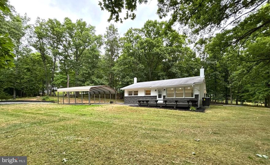 Discover the tranquility and comfort awaiting you! Nestled on just over an acre of serene landscape, this immaculately remodeled home offers a perfect blend of comfort and tranquility. Upon arrival, you are greeted by shaded side and front yards, ideal for enjoying quiet mornings or evening strolls. A wet weather creek adds to the tranquility of rural life with the perfect blend of comfort and natural beauty. The spacious front porch beckons relaxation, while a rear covered porch just off the kitchen promises delightful outdoor entertainment. Inside, the home features three bedrooms and one bath, all tastefully renovated. A highlight is the custom tile shower in the bathroom, adding a touch of luxury to your daily routine. Enjoy the convenience of new appliances, windows that invite natural light, and a state-of-the-art heat pump ensuring year-round comfort. For additional space, an unfinished basement invites your creativity—whether for storage or creating a dream rec room. Convenience meets rural charm with a detached carport to shelter vehicles during winter and the proximity to town, ensures peace and accessibility in one delightful package. A freshly completed survey ensures peace of mind. Don't miss the opportunity to make this property your own. It truly does offer the best of both worlds!