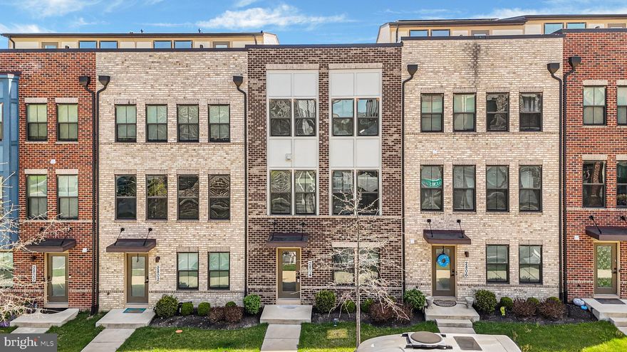 Welcome to 2804 Lewis Avenue, an exceptional residence perfectly positioned within the highly sought-after Village of Towne Square community — where modern comfort, thoughtful design, and everyday convenience come together seamlessly. Built in 2019 and freshly refreshed with brand-new paint and carpeting, this beautifully maintained brick-front townhome immediately impresses with its contemporary portico entry and welcoming curb appeal, complemented by ample guest and street parking for effortless entertaining. Step inside to sun-filled interiors defined by a warm, natural palette and durable luxury vinyl plank flooring that flows throughout the home’s main living areas. The entry level offers remarkable flexibility, featuring a private bedroom with elegant French door entry and recessed lighting — ideal for guests, a home office, or multigenerational living — along with a spacious storage closet, coat closet, and a fully finished two-car garage with abundant storage solutions. Ascending to the heart of the home, the main living level unfolds into an inviting open-concept design crafted for both daily living and entertaining. A stunning chef’s kitchen anchors the space, showcasing stainless steel appliances, a deep stainless steel sink, designer backsplash, expansive pantry, and generous prep and gathering areas. The adjoining dining space and breakfast nook create the perfect setting for morning coffee or evening hosting, while the family room offers comfort and sophistication with crown molding, plush carpeting, and abundant natural light. A well-appointed powder room completes this level with both style and convenience. The upper living quarters provide a peaceful retreat highlighted by a luxurious primary suite designed for relaxation. Featuring custom walk-in closet built-ins and refined window treatments, the suite continues into a spa-inspired ensuite bath complete with granite double vanity, elegant stone countertops, soaking tub, and a beautifully tiled walk-in shower with built-in seating. Two additional bedrooms offer comfortable accommodations with ample closet space and natural light, serviced by a full hall bath featuring granite finishes and tiled flooring. A conveniently located upper-level laundry area enhances everyday ease and functionality. Beyond the home itself, residents of the Village of Towne Square enjoy a vibrant, connected lifestyle in one of Suitland’s most convenient locations. The community offers beautifully maintained common areas and walkable surroundings while placing you minutes from major commuter routes, Joint Base Andrews, and downtown Washington, D.C. Nearby shopping, dining, and entertainment options include Towne Square at Suitland, National Harbor, and an array of local restaurants, retail centers, and parks. Easy Metro access makes commuting effortless, blending suburban comfort with unmatched urban accessibility. This is more than a home — it is a turnkey opportunity to experience modern living, thoughtful design, and prime location all in one exceptional offering.