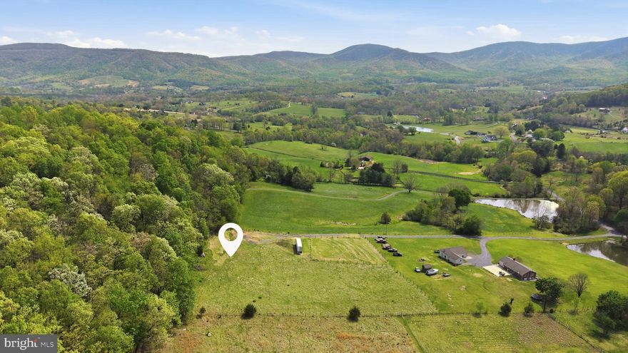 This stunning 11+ acre property on Bentonville Rd in Bentonville, VA sits right at the base of Round Mountain and offers breathtaking views of Skyline Drive and the surrounding Blue Ridge Mountains. If you’ve been dreaming of building a home where nature is your backdrop, this one truly delivers.
The land is partially cleared with multiple potential homesite locations, giving you the flexibility to design exactly what you envision—whether that’s a private getaway or a full-time residence with room to roam. Even better, much of the heavy lifting has already been done for you. The owner has secured a well permit through VDH and installed a 4-bedroom conventional septic system, saving you significant time, money, and hassle before you even break ground. VDH records are available for your review.
Outdoor lovers will appreciate the easy access to nearby hiking trails, parks, and all the natural beauty this area is known for. Whether you’re exploring the mountains, enjoying scenic drives, or simply taking in the peaceful surroundings, this location offers the perfect blend of privacy and adventure. The best part all of this is easy to access off a flat and paved state maintained road!
Opportunities like this don’t come along often—so don't miss out on ready-to-build acreage with views and a prime location.