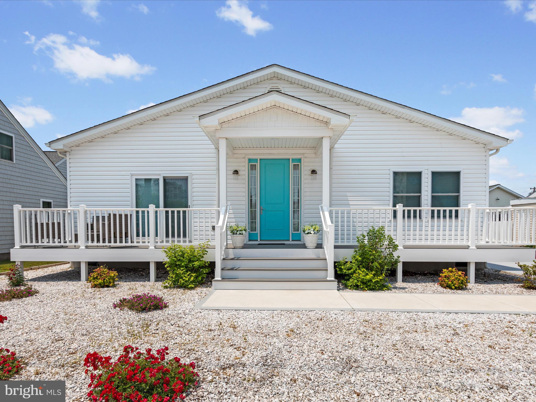 Welcome to your beautiful coastal retreat! This stunning home offers the perfect blend of modern comfort and relaxed coastal charm! Enter through the the oversized front door into an open-concept design, featuring luxury vinyl tile flooring and a neutral color palette throughout. The home was thoughtfully designed with a split-bedroom floorplan, offering privacy, but yet easy access to the living room and kitchen. Wow! The kitchen- It's a chef's dream, with beautiful quartz countertops, stainless steel appliances, white soft-close cabinetry and a large center island-perfect for entertaining or everyday living. The generous primary suite features a sliding glass door to the rear deck, a large walk-in closet and a primary bath with two separate vanities and a large walk-in shower. On the opposite side of the home, you'll find two additional nicely sized bedrooms and a full guest bath, ideal for family or visitors. A rear laundry room adds convenience and functionality to this layout. Enjoy the outdoors on either the rear or front deck-the perfect spot to soak in the ocean breeze. Additional features include a concrete driveway and several storage sheds to the rear of the property. Don't miss your chance to own this beautiful low-maintenance beach house- you're perfect getaway or year round home!