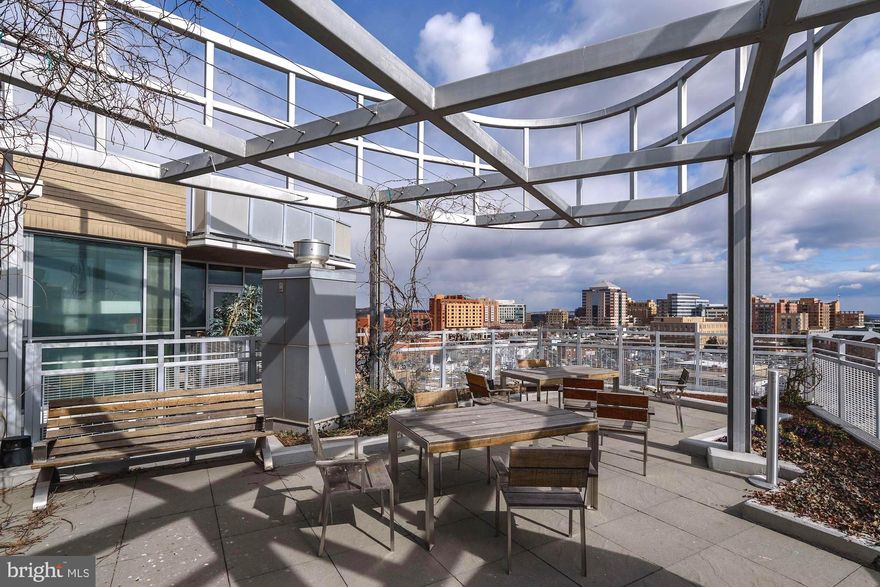 Fabulous, rarely available penthouse provides striking Virginia skyline vistas and 9' ceilings.  The well-designed, open floorplan is nicely balanced end-to-end with private bedrooms and en suite full baths.  Loft-inspired ductwork and textured concrete walls enliven dining and living space.  An expansive breakfast island,  gleaming quartz countertops,  custom backsplash, abundant cabinetry,  large pantry and stainless steel appliances comprise the gourmet kitchen.  The primary bath provides a double vanity, shower and soaking tub.  There is a separate powder room, stacked washer/dryer, assigned garage parking space (B2-42) and storage unit (29).   Steps down the hall is the expansive outdoor Rooftop Terrace.  Building amenities include Concierge (all days 9-5) , 24/7 Fitness Room and bike storage.  Prime location two blocks from Virginia Square Metro; near restaurants, cafes, Whole Foods, Trader Joe's and parks.  CVS coming soon.  Furnishings, rugs, decorative and kitchen items negotiable.