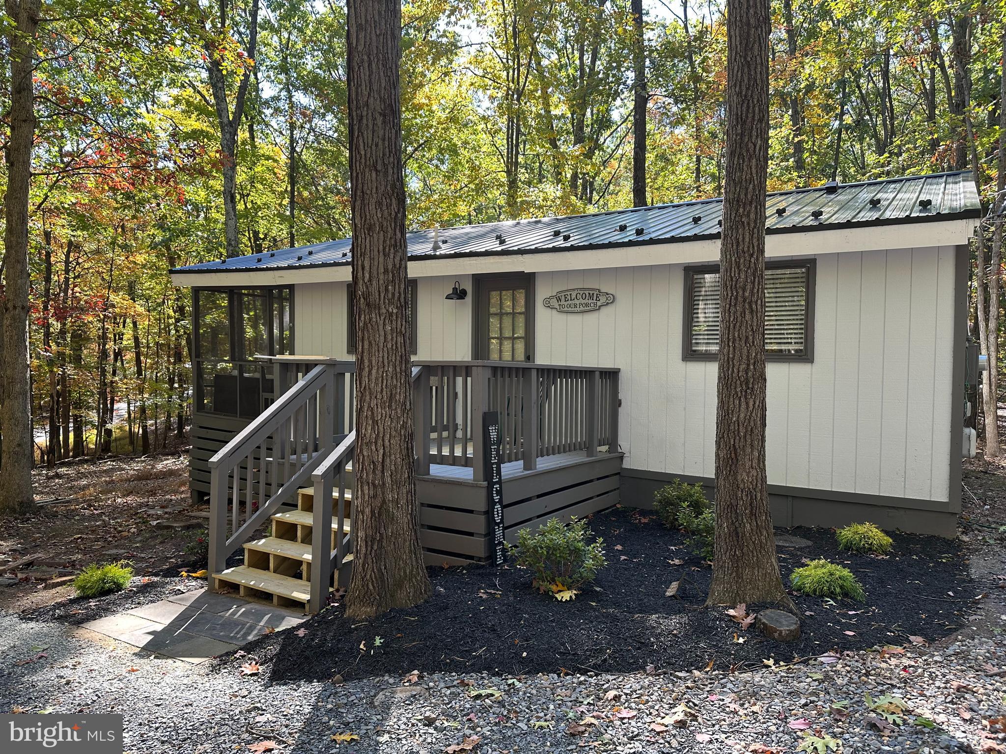 Welcome to 522 Tuckahoe Trail! Immaculately maintained, secluded wooded corner lot, two bedroom and a beautiful bath. Currently under construction! The Seller has professionally painted the exterior and interior of this adorable lodge home. They have added a NEW Metal roof, All new stainless appliances, beautiful granite counters and new light fixtures and fans! The home is equipped with central heat and air, mini split with back-up electric baseboard . It's located on corner wooded lot . Vaulted ceilings through out. Screened in porch off of the great room to enjoy your morning coffee or relax in the evening with a glass of wine. Cozy up in front of the wood burning fireplace with slate hearth and wood mantle.
Class B membership available.