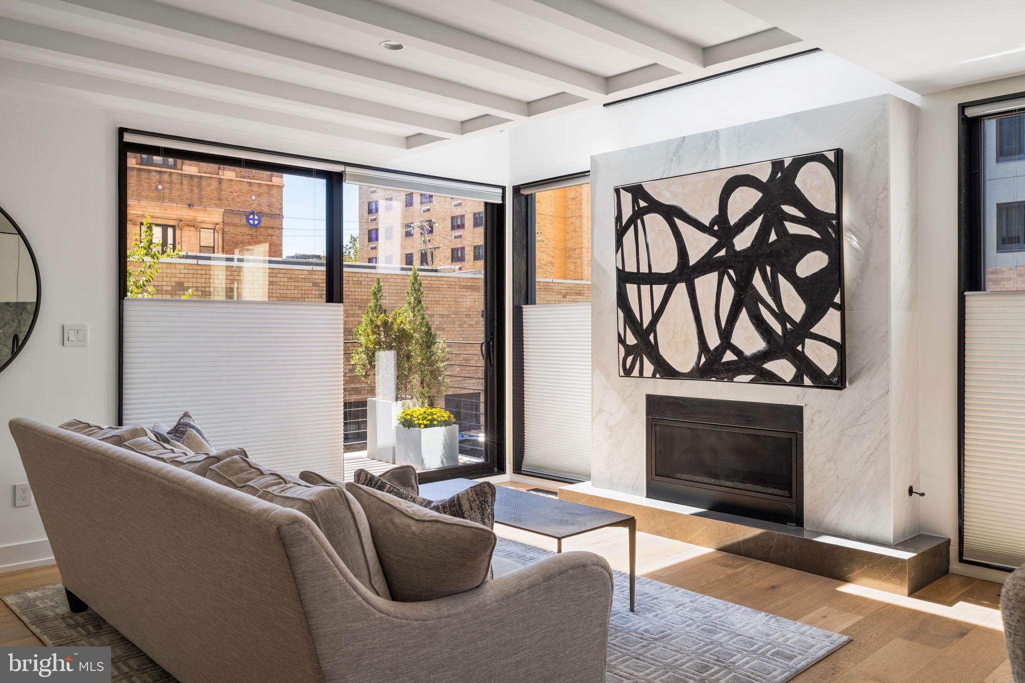 The ideal intersection of approachable and luxurious. Quiet elegance awaits in this truly distinctive and exquisitely crafted two-year-old residence. This home doesn’t just invite you in; it rolls out a red carpet and hands you a glass of champagne the moment you arrive.
The exterior stuns in black and white with a clean brick facade juxtaposed with a beautifully patinaed corrugated metal. The tall mid-century solid wood front door? Oh, it knows it’s fabulous. And those over-sized aluminum black framed windows? It’s just showing off now.
From the first step inside you wonder, "Did I just step into a home decor magazine?" Yes. Yes, you did. The ground floor entry boasts a dreamy foyer complete with slate floors, plenty of storage and bench seating with a hall leading to the oversized one-car garage. A bedroom perfect for a guest suite or a home office and a full bath round out the floor.
Upstairs, you're greeted with soaring ceilings, exposed beams, and a gas fireplace ready to keep things cozy. Oh, and did we mention the floors? Stunning white oak, carefully laid throughout like the runway your feet have always deserved.
Now, the kitchen. You know that dream kitchen you’ve been Pinterest-ing for years? It’s real, and it’s here. Stone countertops and backsplash, custom European-style flat cabinets so gorgeous they’ll make you forget how to cook (or maybe finally inspire you to start), and a massive waterfall island where your plans to gather with friends and family will come to life. A huge walk-in pantry will help you justify your Costco membership while matte black hardware and fixtures add a sleek, modern touch, and Bosch and Fisher Paykel appliances will make even a frozen pizza feel gourmet. A walk-out balcony with floor-to-ceiling glass windows is perfect for soaking in those breathtaking city views while sipping your morning coffee (or wine—we don’t judge). Continue to the dining room flooded in natural light from its large east-facing window and imagine it filled with the laughter of family and friends on infamous game nights.
As you wander through the home, you’ll discover four more generously sized bedrooms, because who doesn't need options? The primary suite? Oh, it’s a showstopper. Think giant walk-in closet and a spa bathroom so luxurious, you might just forget you’re not at a 5-star hotel. Full glass shower stall? Check. Custom double vanity? You bet. Private water closet? Naturally. It’s everything you'd expect from a home of the highest distinction.
The piece de resistance of the home may not even be the home itself but rather the extraordinary roof deck. A truly magnificent cherry on top, experience unobstructed views of the city’s skyline, where the sunsets are what dreams are made of. A full outdoor kitchen complete with a beverage fridge and a top-of-the-line grill, allow for year-round enjoyment. Outdoor dinners never looked this chic.
Finally, if you think stairs are so last century—don't worry, you’re covered with your very own private elevator. Yes, an elevator. Because why walk when you can glide effortlessly from floor to floor?
A private escape in the heart of the bustling Graduate Hospital community, you are in walking distance to much of the best of the city. You’ll love neighborhood favorites, Ultimo Coffee, Sabrina’s and Loco Pez. Get your green fix at nearby Marian Anderson Park and the Schuylkill Banks waterfront. The subway connects you to Center City and the stadiums and the South Street Bridge to West Philly, home of CHOP and UPENN. You are just a few blocks from Philadelphia's celebrated Rittenhouse Square where you’ll find some of the best restaurants and shopping the city has to offer.
This home is the kind that checks every box and then some. Elegant, timeless, and so full of charm, you’ll never want to leave. But when you do, you’ll be bragging about it to anyone who’ll listen. Pop that champagne, you’re home.
