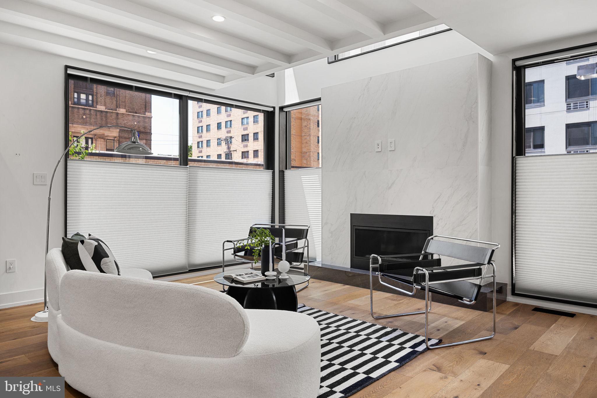 The ideal intersection of approachable and luxurious. Quiet elegance awaits in this truly distinctive and exquisitely crafted two-year-old residence. This home doesn’t just invite you in; it rolls out a red carpet and hands you a glass of champagne the moment you arrive.
The exterior stuns in black and white with a clean brick facade juxtaposed with a beautifully patinaed corrugated metal. The tall mid-century solid wood front door? Oh, it knows it’s fabulous. And those over-sized aluminum black framed windows? It’s just showing off now.
From the first step inside you wonder, "Did I just step into a home decor magazine?" Yes. Yes, you did. The ground floor entry boasts a dreamy foyer complete with slate floors, plenty of storage and bench seating with a hall leading to the oversized one-car garage. A bedroom perfect for a guest suite or a home office and a full bath round out the floor.
Upstairs, you're greeted with soaring ceilings, exposed beams, and a gas fireplace ready to keep things cozy. Oh, and did we mention the floors? Stunning white oak, carefully laid throughout like the runway your feet have always deserved.
Now, the kitchen. You know that dream kitchen you’ve been Pinterest-ing for years? It’s real, and it’s here. Stone countertops and backsplash, custom European-style flat cabinets so gorgeous they’ll make you forget how to cook (or maybe finally inspire you to start), and a massive waterfall island where your plans to gather with friends and family will come to life. A huge walk-in pantry will help you justify your Costco membership while matte black hardware and fixtures add a sleek, modern touch, and Bosch and Fisher Paykel appliances will make even a frozen pizza feel gourmet. A walk-out balcony with floor-to-ceiling glass windows is perfect for soaking in those breathtaking city views while sipping your morning coffee (or wine—we don’t judge). Continue to the dining room flooded in natural light from its large east-facing window and imagine it filled with the laughter of family and friends on infamous game nights.
As you wander through the home, you’ll discover four more generously sized bedrooms, because who doesn't need options? The primary suite? Oh, it’s a showstopper. Think giant walk-in closet and a spa bathroom so luxurious, you might just forget you’re not at a 5-star hotel. Full glass shower stall? Check. Custom double vanity? You bet. Private water closet? Naturally. It’s everything you'd expect from a home of the highest distinction.
The piece de resistance of the home may not even be the home itself but rather the extraordinary roof deck. A truly magnificent cherry on top, experience unobstructed views of the city’s skyline, where the sunsets are what dreams are made of. A full outdoor kitchen complete with a beverage fridge and a top-of-the-line grill, allow for year-round enjoyment. Outdoor dinners never looked this chic.
Finally, if you think stairs are so last century—don't worry, you’re covered with your very own private elevator. Yes, an elevator. Because why walk when you can glide effortlessly from floor to floor?
A private escape in the heart of the bustling Graduate Hospital community, you are in walking distance to much of the best of the city. You’ll love neighborhood favorites, Ultimo Coffee, Sabrina’s and Loco Pez. Get your green fix at nearby Marian Anderson Park and the Schuylkill Banks waterfront. The subway connects you to Center City and the stadiums and the South Street Bridge to West Philly, home of CHOP and UPENN. You are just a few blocks from Philadelphia's celebrated Rittenhouse Square where you’ll find some of the best restaurants and shopping the city has to offer.
This home is the kind that checks every box and then some. Elegant, timeless, and so full of charm, you’ll never want to leave. But when you do, you’ll be bragging about it to anyone who’ll listen. Pop that champagne, you’re home.