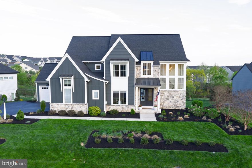 Stunning in design and detail, this 5-bedroom, 4.5-bath home by Pine Hill Building Co. offers a thoughtfully designed layout and exceptional craftsmanship. A striking two-story foyer makes an immediate impression, where a grand staircase framed by wrap-around windows fills the space with natural light and creates a sense of openness from the moment you enter.
The main level is both open and well-defined, anchored by wide-plank white oak flooring, rich wood beam accents, and designer lighting that adds warmth and character throughout. At the center of the home, the chef’s kitchen is designed for both function and gathering, featuring an expansive 10-foot island, quartz countertops, GE Café appliances, and a custom hood accented by detailed tilework. A walk-through scullery and pantry, complete with a second dishwasher, beverage refrigerator, built-ins and floating shelves, offers both convenience and additional prep space, and leads to a well-designed mudroom.  The adjoining family room is highlighted by a linear gas fireplace and a wall of windows, creating a bright, inviting space for everyday living and entertaining. A private home office and first-floor guest suite provide flexibility without compromising design.
Upstairs, the owner’s suite offers a true retreat with a spa-like bath featuring a walk-in tile shower, integrated soaking tub, heated floors, and custom closet built-ins. Additional bedrooms include a private en-suite bedroom and two bedrooms connected by a Jack and Jill bathroom, along with a well-positioned second-floor laundry room.
Architectural details such as custom trim work, and thoughtfully designed built-ins add depth and character throughout the home. Expansive windows and a light-filled dining area lead to the rear deck with steps to the backyard, creating a seamless connection to outdoor living. The daylight lower level offers additional flexibility for future living space. Smart home features, whole-house water filtration, reverse osmosis, water softener, and a security system further enhance comfort and convenience.
3 car garage with a seperate third garage bay featuring a full wall of built-in storage and a slatwall organization system.  Spacious, almost half acre lot. 
This beautifully crafted home offering refined finishes, exceptional natural light, and a well-designed layout in a premier Lititz location close to shopping and everything Lititz has to offer!