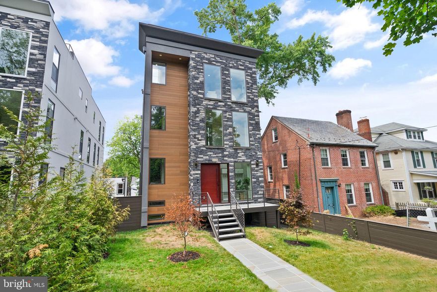 Nestled in the heart of Chevy Chase, DC, lies the exquisite property at 6118 30th St NW, a beacon of luxury living and modern elegance, boasting a prime location near Rock Creek Park. Upon arrival, step inside, and you'll discover a sanctuary of luxury finishes and thoughtful features designed for the discerning homeowner. Every element exudes sophistication and charm from the striking modern chandeliers to the rich, red oak hardwood floors. Sunlight floods the interior, illuminating the space and accentuating its beauty. The first floor showcases an impressive array of premium touches, including an elevator for seamless access to each level. The kitchen is a culinary masterpiece with a convenient coffee station and high-quality finishes such as German-imported Leicht cabinets, Wolf & SubZero appliances, and Dekton countertops. High ceilings throughout the home create an atmosphere of openness and grandeur, while lofted ceilings in the rear family room add a touch of architectural intrigue. Ascend to the second floor, where three spacious bedrooms await. Two bedrooms share a large full bath, while a third bedroom offers its own en-suite, providing comfort and privacy for residents and guests alike. Venture to the third floor, and you'll discover the epitome of luxury: the primary bedroom suite. Spanning the entire floor, this sanctuary features a bright lounge area with a wet bar, for private times of relaxation, as well as indulgence. A half bath allows for privacy. Lose yourself in the freestanding soaking tub, surrounded by imported Porcelanosa tiles; peruse your wardrobe in one of two expansive walk-in closets. As night falls, retreat to the perfectly appointed bedroom, gleaming with soft lighting and unparalleled comfort. For those seeking panoramic views of NW DC, a private rooftop deck awaits, offering a serene escape.  The basement includes a bedroom and full bath and multiple entertaining spaces for any occasion.  One great addition to the basement is the au-pair suit, which is separate from the interior basement space. The au-pair spaces include one bedroom, a full bath, a washer and dryer, and a full kitchen.  Two parking spaces are at the rear of the property.