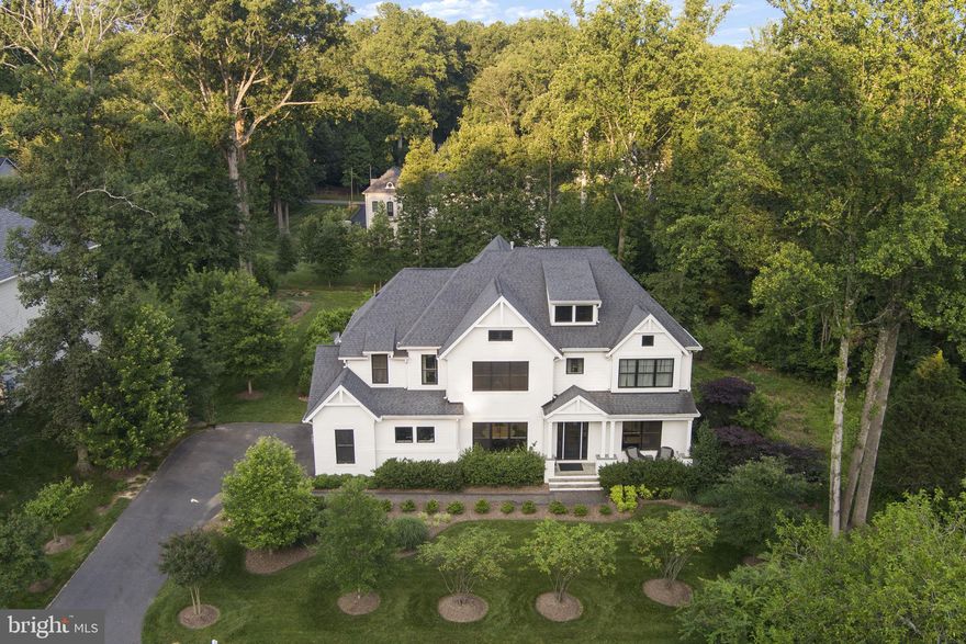 **Luxury Living in the Heart of Great Falls**

Welcome to one of the most beautiful homes in Great Falls—this white brick and Hardy plank home offers the perfect blend of luxury, location, and livability. Nestled on a beautifully landscaped half-acre lot less than half a mile from the Village Center, this elegant residence places you just steps from local restaurants, parks, Starbucks, and the conveniences of The Village.

 Inside, you’re greeted by a glass front door, gleaming white Oak hardwood floors, extensive millwork including crown, wainscoting, chair rail, and raised panel moldings that speak to the home’s craftsmanship. The main level includes a formal dining room with exquisite moldings, a butler’s pantry with custom cabinetry and wine fridge, and a richly appointed library that doubles as a main-level bedroom with a full bath—featuring architectural tile and high-end finishes.

 At the heart of the home is a stunning open-concept kitchen and family room. The kitchen is a chef’s dream: commercial-grade Stainless Steel range hood as well as six-burner range with double ovens, a third oven, warming drawer, inset cabinetry with antique mirrored glass, oversized built-in refrigerator/freezer, and gorgeous stone countertops. A spacious breakfast area overlooks the backyard oasis. The family room boasts built-in bookcases, abundant natural light, and a cozy fireplace.
 
Just off the kitchen, the back hallway leads to two large walk-in pantries, a mudroom with cubbies and coat hooks, and built in cabinets and direct access to the garage.

Upstairs, you’ll find four spacious bedrooms, each with its own beautifully tiled en-suite bath and walk-in closet. The luxurious primary suite features a spacious bedroom with sitting area, two walk-in closets with custom Built-ins, a separate illuminated shoe closet, and a spa-inspired bath with furniture styled vanities, makeup area, glass-enclosed shower, soaking tub, and a frosted glass wall that seperates the water closet.

 The walk-up lower level is equally impressive, offering a large recreation room with billiards and media areas, an exercise room with rubber flooring, a full bar, wine cellar, and a fifth bedroom and full bath—perfect for guests or extended family.

Outside, the private backyard is a true retreat. Enjoy a spacious slate patio with built-in stone fireplace, dual seating areas, and dining space. A lush flat lawn, mature landscaping, koi pond water feature complete the serene setting.

This home offers timeless elegance, top-quality finishes, and a location that’s second to none. Contact us today to schedule your private showing.