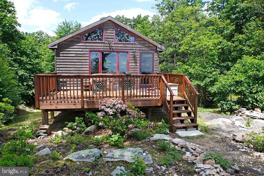 Amazing 4 state views from the deck of this mountaintop retreat!! This very  unique property, bordered  by 38,000 acres of wildlife preserve,   is situated at the end of the road and offers maximum seclusion.  Drive in is 1.5 miles long , no neighbors in sight! Enjoy the peace and quiet, abundant wildlife and incredible sunrises all year long! At night, the darkness of the area allows for amazing star viewing.  The interior of the cabin offers a spacious , open floor plan with hardwood floors on the main living level.  The granite countertops were imported from Italy. There are 2 full bathrooms, one on each level, that could be two separate living areas, perfect for guests or use as a vacation rental. The exterior features a large rear deck, a cleared meditation area in the woods, walking trails, a well established fire pit for bonfires and an outside water pump. There is also a 20 foot sea container for protected storage with electric and exhaust fans, a water line has been run to the container but not hooked up. Four 6x6's have been set in concrete and rise 8' for a tree fort to be built on stilts.  There is also an extra shed for additional storage.  Well pump is relatively new.   And, this property has great cell service  (5G) so you can get internet connection via a Personal Hotspot ! This is a truly amazing , one of a kind property! Call today for your viewing!