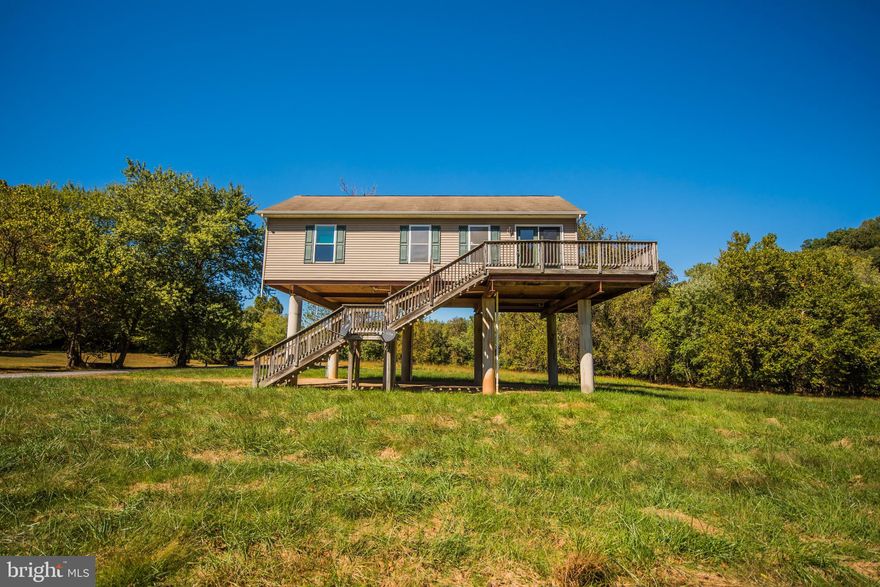 Location, Location, Location less than 8 miles to Berkeley Springs. Modular Ranch style waterfront home on the Cacapon River, built out of the flood plan. 250 ft on the Cacapon River. 1008 sq ft home with 3 bedroom, 1.5 bathroom, kitchen and living room with pellet stove.  Wrap around deck to enjoy the views on.  2.08 acres lot mostly cleared, trees by the river.  A must see when looking for that waterfront property.