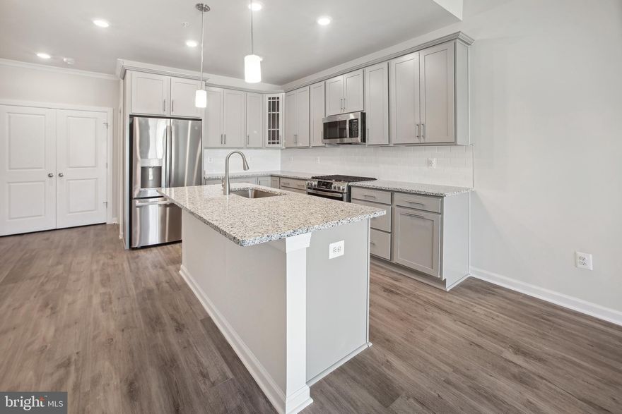 New construction available for immediate move in! Beechfield Manors is the ONLY New Active Adult 55+ Community in Prince George's County. A planned community with a clubhouse, fitness center, fire pit and swimming pool is located off Enterprise Road in Bowie MD. This three-story home has 3,281 sq ft., 3 bedrooms, 3.5 bath with a 2 car garage, and is designed for comfortable living for our amazing 55+ community. This brand new attached interior home has an owner's suite located on the main level in the back of the home and includes an in-suite bathroom with a large shower with seat for comfort, and a walk-in closet. The laundry room (washer and dryer are included) is also conveniently located on the main level as well. There is a grand two-story great room with fireplace positioned adjacent to your kitchen that showcases grey cabinets, granite countertops and stainless steel appliances. Your guest bedrooms and huge loft (overlooking your great room) are located upstairs along with a full bath and an extra storage room that could double as an office or an amazing wardrobe. Finally, your large finished lower level will feature a finished wet bar with included beverage center, a walk-out exit, and a full bathroom along with ample storage space. Seller closing assistance and SPECIAL financing rates are available with in-house lender Lennar Mortgage.