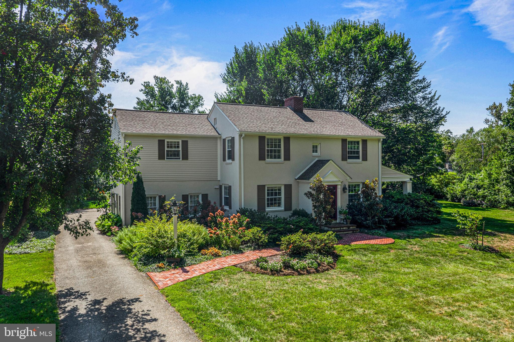Welcome to 219 S. Ithan Avenue, a classic 4 BD, 2.5 BA colonial on an oversized .86 acre lot in the popular BROWNING LANE neighborhood of Bryn Mawr. Set in the award-winning Radnor School District, this charming home features many updates and an expansive lot. Inside, the renovated Kitchen overlooks a sunny Family Room addition, creating the perfect hub for gatherings and everyday living. Two Butlers Pantry areas in the Kitchen provide additional cabinet space and are great for entertaining. Enjoy hosting friends and family for meals in the Dining Room. The Living Room has built-ins, a fireplace, and a door to a covered side Porch, which could easily be enclosed to create a private Office. Upstairs, the Primary Bedroom is a true retreat with multiple closets and a renovated en suite Bath featuring a marble-topped vanity and a glass-enclosed stall shower. Three additional Bedrooms share a well-appointed Hall Bath, providing comfort and versatility for family or guests. The Lower Level offers a finished space that can be used as a Recreation Room, Playroom, or Home Gym plus a large unfinished Utility/Storage/Laundry Room. Sturdy stucco over solid block construction. Enjoy summer barbecues on the expansive rear patio, and recreation or gardening in the beautifully landscaped yard, surrounded by mature plantings for privacy. The 2-car rear entry Garage adds extra ease to daily life. This home is part of the sought-after Browning Lane neighborhood, which has a warm sense of community and activities that foster lifelong friendships. Easy access to top-ranked schools, including Radnor Elementary, and within walking distance to restaurants, train stations, Villanova University, Agnes Irwin School, parks, and playgrounds. Convenient to the Blue Route, Center City, Airport, and to shops and restaurants in the charming villages of Wayne and Bryn Mawr. Don't miss the opportunity to make this exceptional property your own. Showings start Thurs. Oct. 2nd.