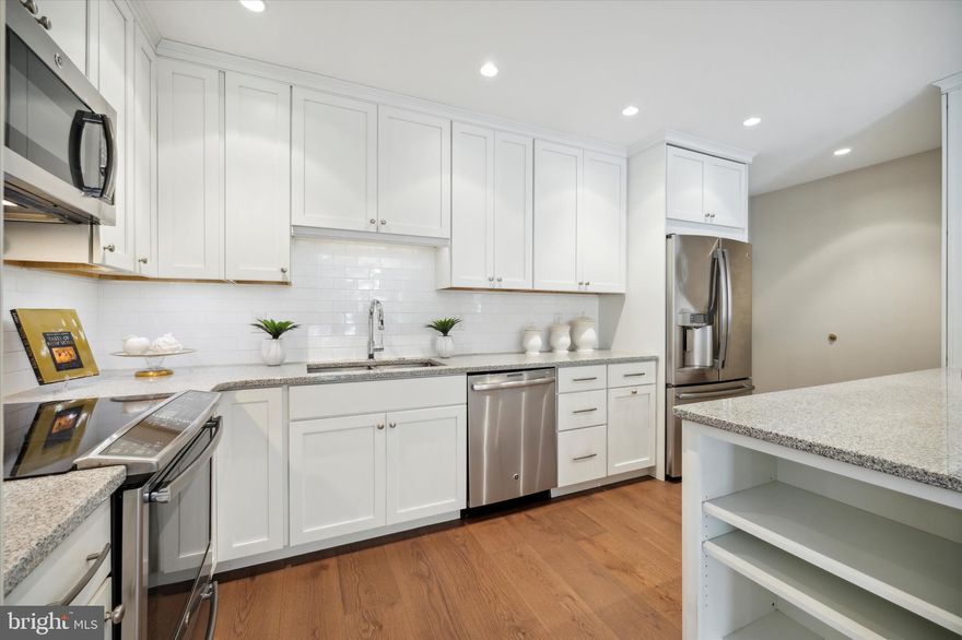 Welcome to 100 Grays Ln Unit 104, a stunning three-bedroom, three-and-a-half-bathroom first floor corner unit condo located in the highly sought-after Main Line town of Haverford. This immaculately maintained home is perfect for those seeking a luxurious lifestyle with all the modern amenities. Renovated from top to bottom and ready for new owners. The newly remodeled kitchen is a chef's dream, featuring stainless steel appliances, granite countertops, stylish backsplash, pot-filler over the electric stove, and premium white cabinets with ample storage, including a custom cabinet for a mixer and additional cabinet storage under the breakfast bar. Cooking and entertaining have never been easier or more enjoyable. The breakfast bar is perfect for casual dining or catching up with friends and family. Enjoy open concept living with the kitchen open to both the dining and living rooms. Featuring two primary en-suites with newly remodeled bathrooms and an additional bedroom (currently used as a library\home office) with a private full bath directly across the hall, this condo offers plenty of living space. The primary suite, closer to the kitchen, has a walk-in California Closet and private dressing area adjoining the beautifully remodeled bathroom. Enjoy radiant heat tiled floors, double sink vanity and easy to access frameless shower. The second primary suite offers a spacious bedroom, nicely remodeled private en-suite bath with tub\shower and a full walk-in closet outfitted with organizers. The third bedroom has been transformed with custom bookcases built by a master carpenter and is a lovely library and work from home space. This room could also be used as guest bedroom and offers a private full bathroom with a tiled stall shower. In addition, there is a remodeled powder room in the main hallway, laundry room with plenty of cabinet storage adjoining the kitchen, and an oversized private patio (larger than most units). The condo has been completely remodeled and offers newer luxury vinyl flooring throughout, high quality carpeting in the primary suites. During the 2015 renovation, the current owners opened the floor plan to create an open concept kitchen and breakfast bar and replaced all windows with new thicker double-paned Pella windows throughout. All original pipes and electric lines were replaced and brought up to code. All flooring was replaced and there is neutral paint throughout the condo. Southern exposure fills the condo with natural light. Enjoy living on the first floor with quick and easy access to the main door and elevator (from the parking garage). The building provides a 24-hour doorman and security throughout. Conveniently located within walking distance to the Haverford Train Station, Merion Cricket Club and shopping and dining available in Haverford. Minutes from Suburban Square. The building does not allow pets. Move in and start living!