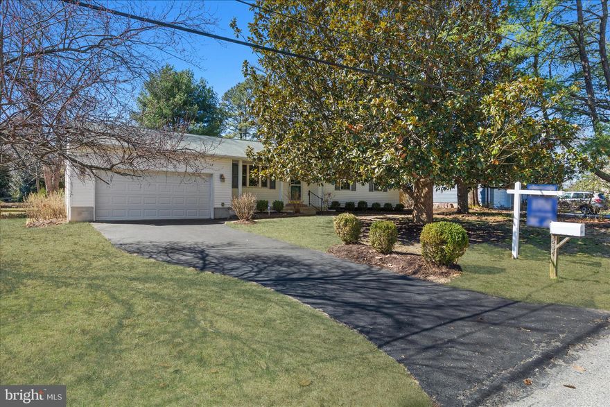 Welcome home to this inviting ranch-style home featuring a welcoming front porch and a layout designed for comfortable everyday living. The updated kitchen is a standout, offering Corian countertops, a KitchenAid six-burner gas range, a  quad-door refrigerator and a Bosch dishwasher—perfect for both daily meals and entertaining. The main level includes a spacious living room and dining area, along with three bedrooms. The primary bedroom features a private half bath, while the additional bedrooms share a full hall bath. Hardwood floors run throughout the main level (under carpet in bedrooms) and offer an opportunity to refinish and make them shine. Just off the kitchen, step out onto the composite deck, an ideal spot for outdoor dining or relaxing while overlooking the lovely and private fenced rear yard. The mostly finished lower level provides excellent additional living space, including a large family room with wall-to-wall built-in bookshelves, perfect for movie nights, a playroom, or a home office area. This level also includes a laundry area, workshop space, and an additional storage room with a cedar closet. Out back, the fenced yard features a charming “She Shed / Man Cave” complete with insulated walls, finished flooring, electricity, and a patio area, offering endless possibilities for hobbies, creative space, or a private retreat. The oversized two-car garage addition offers room for two cars and plenty of storage. New owners always like to know the ages of the HVAC and water heater; they are 2019. The owner was not sure of the roof's age. Located in a community with water access and within the highly desirable Severna Park feeder school system, this home offers comfort, versatility, and a prime location.