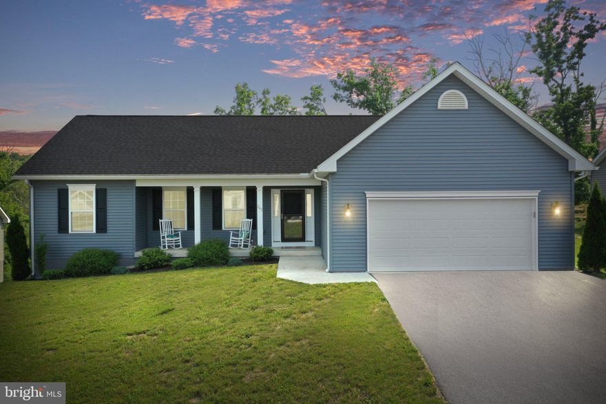 Offered for sale is this gorgeous 3 bed, 2 bath ranch-style home located in the desirable Bridle Creek community of Martinsburg, WV. This home has a split bedroom design and features an open-concept floor plan. Highlights of the main living area include the beautiful light brown LVP floors, quality painted cabinets, stainless appliances, and white quartz countertops. On one end of the house, you will find two bedrooms and a hall bath. The opposite end is home to the primary bedroom featuring a large walk-in closet and ensuite bath. This bathroom includes a dual vanity and a large walk-in shower with a frameless glass door. The laundry room is conveniently located near the primary bedroom and garage entrance. The garage walls have been insulated, drywalled, and painted. In addition, a platform has been installed at the stairs to the interior door. The platform's flooring is designed to lift up, which makes for an excellent storage solution. The full walk-out basement remains unfinished, providing a blank slate for new owners to finish to fit their needs if desired. The basement leads out to a large patio shaded by the above deck. The rear of the house has a private setting not found with most homes in the community. The lot backs to a wooded area, and a path from the backyard connects with the community nature trails that meander throughout the neighborhood. Some of Bridle Creek's amenities include a basketball court, pavilion, playground, and a private fishing pond. Schedule a private tour of this beautiful home today!