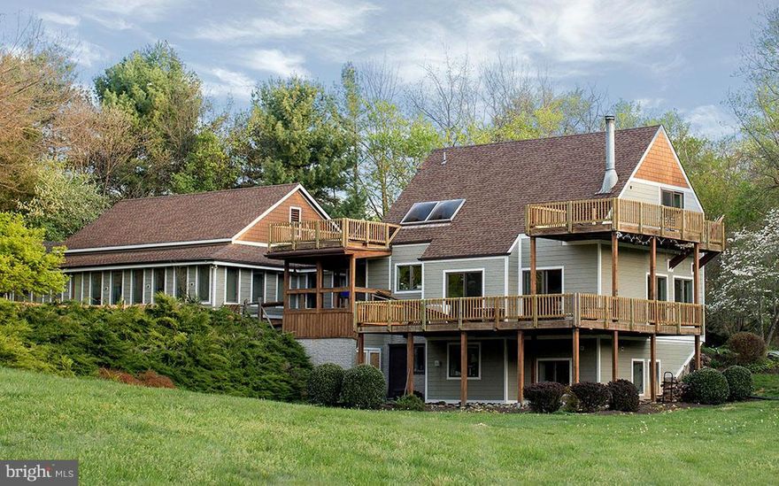 AMAZING NEW PRICE for an Architectural Gem sited on 2 lush acres, beautiful Darnestown w/easy commute to D.C.  Frank Lloyd Wright inspired home w/ non-traditional open floor plan, vaulted ceiling, light everywhere w/ floor to ceiling windows/doors, various decks.Updated kitchen/bath,gleaming hardwd flrs, Master bedrm w/loft. Expansive Studio for 3 car gar photography/yoga/dance