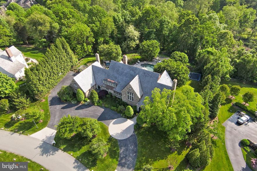 This sensational Stone, English Country Masterpiece built by Brendan O’Neil and designed by Architect David Jones is elegantly sited on a spectacular professionally landscaped 2.79-acre lot featuring panoramic and scenic views! The backyard oasis has won architectural design awards in the Mid-Atlantic! Enjoy the views of rolling hills and mature trees as you sit on the porch that spans the entire back of the house or relax at the saltwater pool with multiple terraces that extend the living space. Also featured are the jacuzzi, built in trampoline with protective netting and built-in stone grill. Gather round the outdoor fireplace at night as you roast marshmallows and sip on wine. Conveniently located inside is a shower, changing area, powder room and washer/dryer.  As you enter the home from one of its two entrances, you will discover extraordinary details with custom millwork, designer materials and expert workmanship throughout. Lush nature and bright light can be seen from almost every room in the house. This home offers tranquility and privacy on one of the most beautiful streets of custom homes in Potomac! The gourmet farmhouse kitchen is perfect for the chef in the family and weeknight meals with a large walk-in pantry, six burner stove, ample beautiful custom cabinets, butler’s pantry with a wine fridge, dishwasher, fridge, and icemaker.  The spectacular great room is sophisticated yet comfortable featuring 16' ceilings and one hundred-year-old reclaimed beams from a Pennsylvania farmhouse that give it a rustic touch. The cozy stone inglenook is ideal for gathering around the fire to sip wine, play games, read, or watch tv! The main level also boasts a den, private office, music room and dining/bar room. The sun drenched second floor includes the private owner's suite with incredible closet space & dressing room, a newly renovated spa inspired luxury bathroom, private veranda, and fireplace. Additionally, a second level family room, guest suite, and three 15' X 15' bedrooms with ensuite bathrooms and laundry room complements the upstairs. The lower-level features multiple work out rooms, a family room, wine cellar, guest suite and full bath. This spectacular Custom English Country home situated in an idyllic oasis is the perfect place to call home and gather with family and friends!