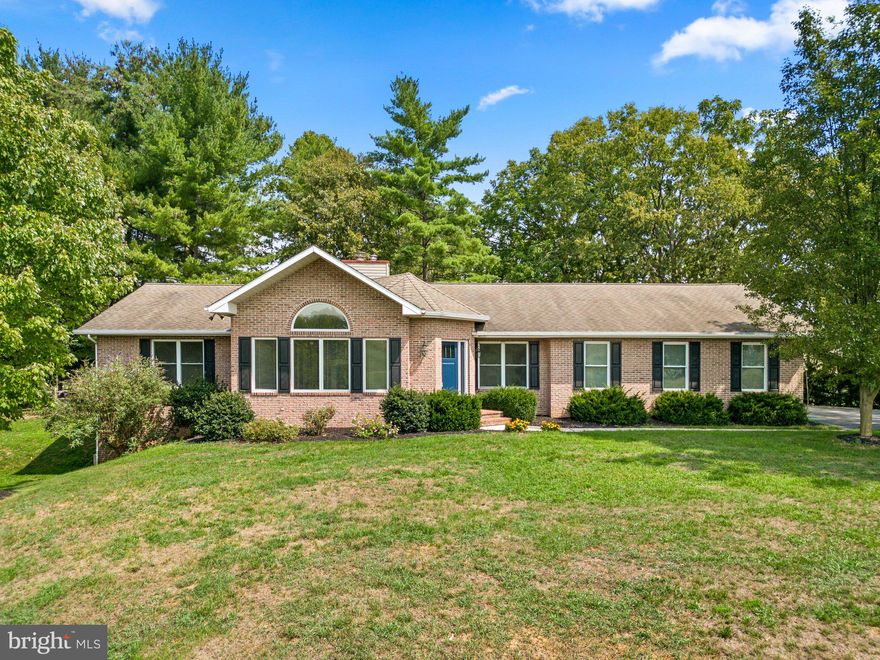 Welcome home to 19414 Manor Church Rd! This stunning property is situated on 5 acres of sprawling land, providing a tranquil retreat nestled amidst picturesque landscapes. As you step through the front door, vast, nearly floor-to-ceiling windows flood the expansive space with natural light. The vaulted ceilings create an immediate sense of openness while the double-sided fireplace serves as an inviting focal point that seamlessly connects to the dining area. The dining area is perfectly positioned to offer peaceful views of the backyard, transforming every meal into a scenic experience. Step through the double doors into the massive fenced backyard, and you'll immediately sense the boundless potential it holds. This great space invites you to explore, create, and unwind in a natural sanctuary that's all your own. Imagine nurturing your green thumb with extensive gardening beds that stretch out before you. A sizable barn as well as a generously sized shed offer a dedicated space for tools, equipment, and gardening essentials. Picture evenings spent gathered around the fire pit, where laughter and stories intertwine with the crackling of the fire. Roasting marshmallows or simply basking in the warm glow, this area is destined to become a cherished spot for making memories with loved ones. Back inside, the kitchen stands as a culinary oasis, designed to inspire the gourmet enthusiast within you. Its well-appointed layout includes a dining area embraced by sweeping bay windows, inviting the beauty of nature as you grab a quick breakfast or catch up on homework. Storage galore! The bar area facilitates seamless food preparation, while a thoughtfully positioned pantry ensures that every cooking essential is readily accessible. Half Bath! Main-level laundry! Three spacious, highly desired, entry-level bedrooms and two conveniently located full bathrooms round out this cozy main floor.  Venturing downstairs, you'll discover two large storage rooms!  The roomy walk-out basement is ideal for a family room or a recreation room, where countless memories will be made. An additional room, versatile enough for a playroom, home gym, or home office as well as a full bathroom, add to the functionality of this space. The attached three-car garage provides ample space for vehicles, storage, and even workshop areas, catering to both functionality and the aspirations of any homeowner. Located in scenic Boonsboro which effortlessly captures the essence of small-town charm. Only minutes from RT 70, ALT 40,  grocery shopping, premium outlets, and more! ***Check out the 3-D tour!***$400 from the sale of this home will go to Baltimore Youth!!** Photos are Virtually Staged