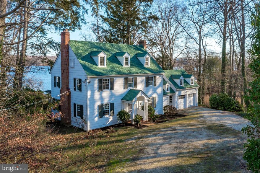 This is your chance to own a piece of history in the prestigious neighborhood of Wardour in Annapolis, MD. Sitting on the Severn River with water views from every level, this 3-story colonial was built in 1935 and is filled with character. Step inside and you are welcomed by the original kitchen, hardwood floors and layout with traditional charm throughout. The main floor offers formal dining and living rooms, butler’s pantry and an inviting sunroom with  gorgeous river vistas and plenty of space for entertaining. Upstairs you will find 5 bedrooms including a primary suite and  2 full baths. The guest suite with full bath is conveniently located over the 2-car garage. 
The rolling back lawn leads to the waterfront where you will find a rare boathouse with roof top deck for watching The Blue Angels, a deep water  pier complete with 3 slips suitable for power or sail boats.  Plenty of parking is available for visitors and friends who want to join you at your new waterfront retreat! This home is minutes from West Annapolis restaurants and shops and minutes from City Dock and the Naval Academy Stadium! This unique waterfront location provides an unbeatable combination of beauty, privacy and convenience that won’t last long. Home sold "As Is".