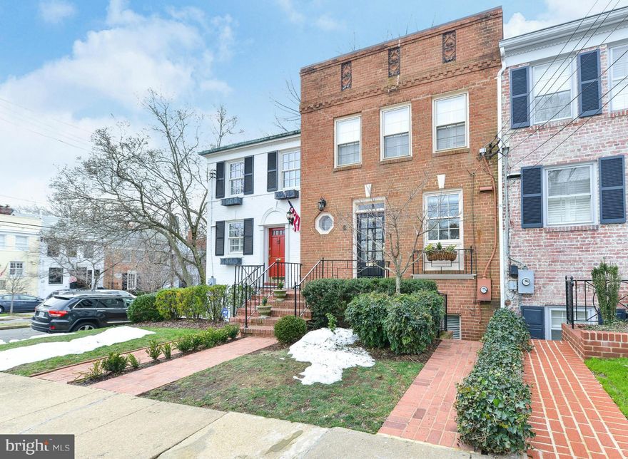 Exceptionally bright and beautifully maintained brick townhouse with front and rear access on two levels.  Glorious white kitchen with high-end appliances, porcelain farm sink and casual eating space. Open main level floor plan with arrangement of space very flexible.  Great built-ins! Easily maintained and delightful rear patio.  Deeded parking.  Short walk to schools, stores and parks!