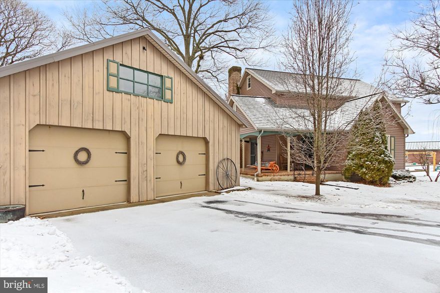 Pride of ownership shows in this one  owner home - was built to look like a farmhouse - buttered plaster,beams in ceiling , stone wood burning fireplace, plank hardwood flooring,  first floor large laundry room with cabinets for storage, 1/2 bath first floor, large eat in kitchen with cherry cabinets,  primary bedroom has 2 large walk-in closets with closet organizers and dressing area with primary bath.  2 car oversized detached garage with electric, wrap around porch and covered patio in rear.    If you like a farmhouse look this home will wow .  New windows in 2021 , New hot water heater in 2020, 2 zone heat, walk up attic for storage.     Home sits back off  N. George Street  a good distance  semi-private .