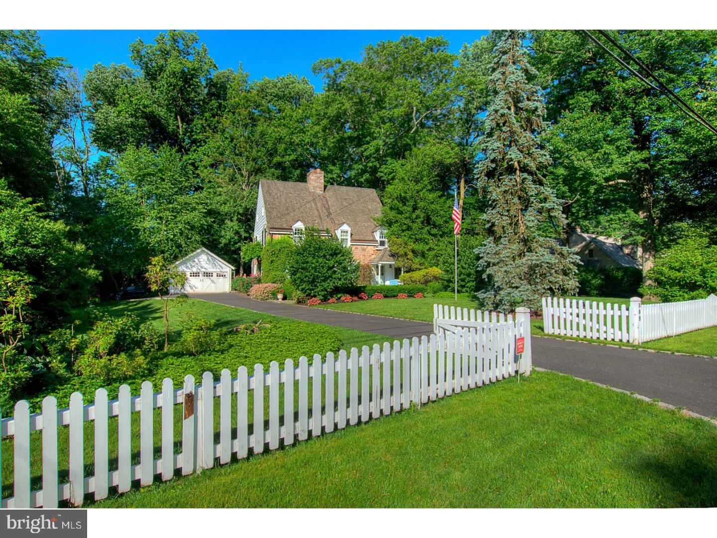 This idyllic stone Colonial with professional landscaping and white picket fence is located in the heart of highly desirable Elliger Park.  Built in 1928 by Philadelphia architect R. Brognard Okie, who was responsible for building beautifully appointed homes on the Main Line and restoring the Betsy Ross House. As you view this home, be sure to notice all the unique charm it has to offer. Walk into the large foyer highlighted by wide window sills, random width pine flooring and convenient powder room. The home has wonderful flow for easily entertaining a crowd.  The large open living/dining space with wood fireplace is flanked by built-in cabinets and features an open bookcase which spans the width of the room.  Lots of windows allow for bright sunlight throughout the day. There is a covered side porch off of the dining area for taking advantage of the private, treed yard.  The kitchen has been redone with Sub-Zero refrigerator, high end GE appliances and center island.  The beamed ceilings and tile floor add to the charm and character of this unique home. The second floor features two full baths, 4 bedrooms with random width pine floors.  The third floor has a cedar closet and with the plumbing is ready for expansion .  Perfectly located close to Ft Washington train station, Rt. 309, PA Turnpike,shopping and the boro of Ambler.