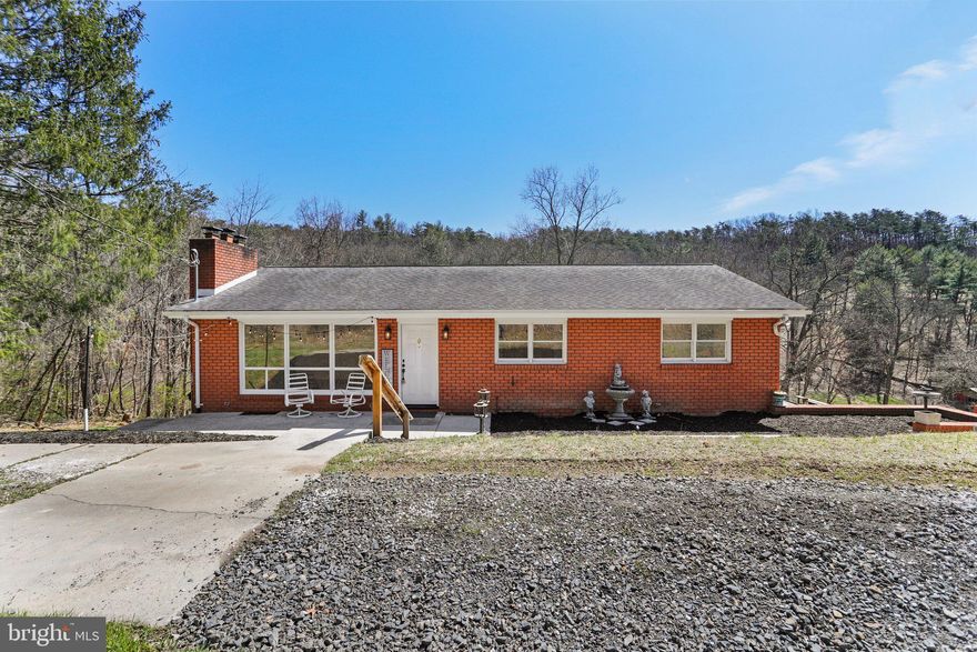 Updated all-brick rancher in Naves Crossroads! Single owner, custom built by the Lindner family. Immediately ready for move-in! Featuring 3 beds, 2 full baths. Hardwood flooring throughout. Main level offers a large living room with a wood-burning fireplace and picture window. Eat-in kitchen with new flooring, new refrigerator, and opens up to the dining area that has a beautiful crystal chandelier. Double-sliding doors that take you out to the spacious backyard deck. Make your way to the basement rec room that has a wood-burning brick fireplace and new carpet. Fully updated full bathroom. Laundry room, mud room, and new water heater. Walk-out level. Oversized 2-car garage, which one area is plumbed for a full kitchen. Outside car lift. A stream that runs across the back of the property. Includes two adjacent parcels, for a total of 3.12 acres. Backs up to a beautiful 19-acre mini farm with horses, alpacas, sheep and chickens. Serene setting, yet not too far from downtown Cumberland with shopping, restaurants, breweries, and the Western MD Scenic Railroad that provides year-round excursions. Many outdoor opportunities for retirees, as well as nearby medical centers in town. Rocky Gap State Park is about 10 minutes away and offers recreational activities such as hiking, camping, swimming, picnicking, and more. About an hour away from Deep Creek Lake. Schedule your showing today or stop by the Open House on Saturday, March 30th from 12-2pm! Don't miss out on this rare opportunity - it won't last long!