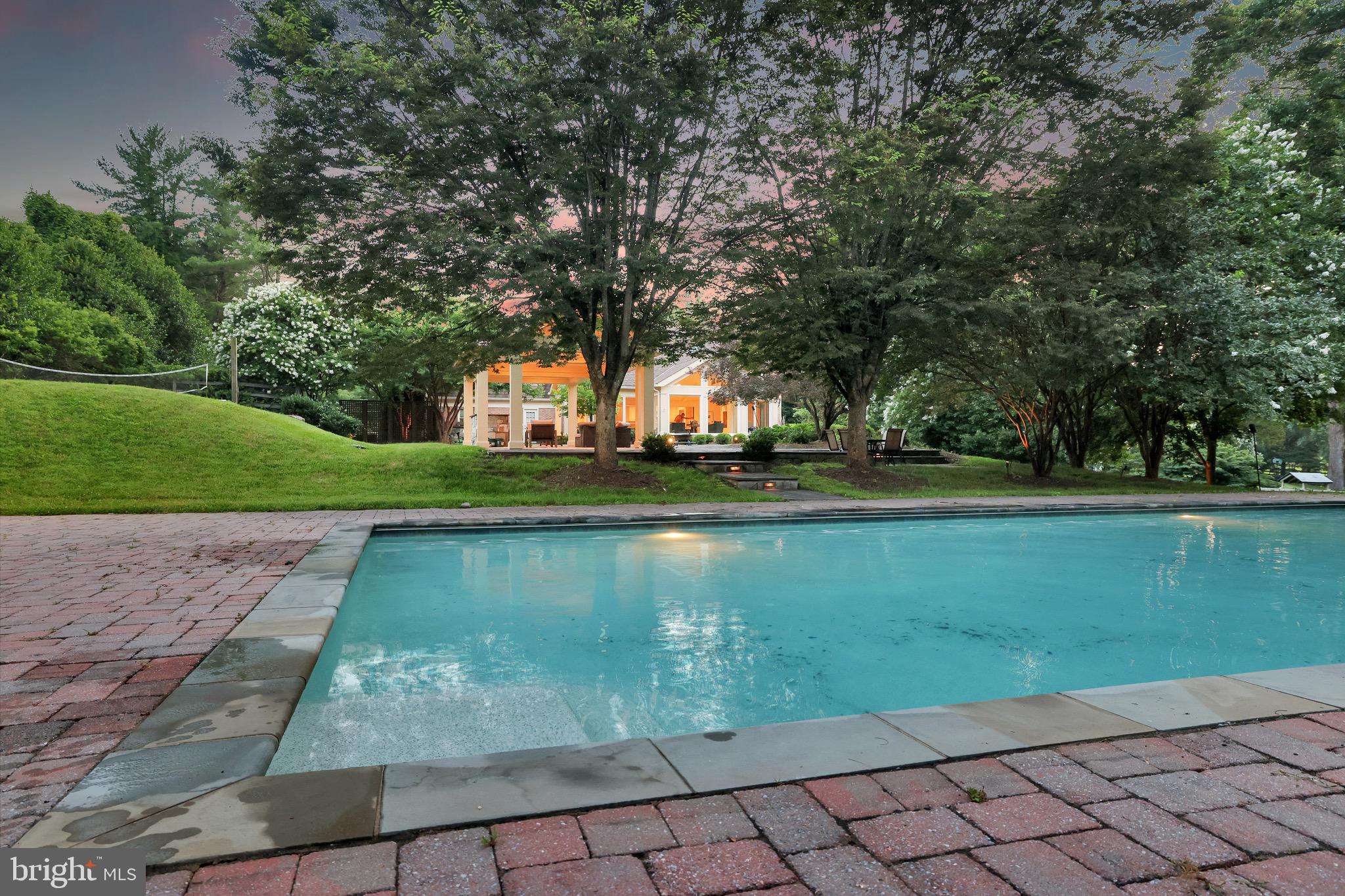Welcome to 12212 Drews Ct, a magnificent residence nestled on a sprawling 2.6-acre estate in the prestigious enclave of Potomac, Maryland. This distinguished property seamlessly blends timeless elegance with modern sophistication, offering an unparalleled living experience tailored for discerning luxury buyers and families alike.
<br>
Refined Interiors for Grand Living
<br>
Upon entering, you're greeted by an inviting foyer that sets the tone for the home’s refined ambiance. The formal living room, adorned with a cozy fireplace, and the stately dining room with built-in sideboards, provide the perfect settings for intimate gatherings and grand soirees. A chic, custom-built office caters to the needs of the modern professional, ensuring both comfort and productivity.
<br>
At the heart of the home lies the gourmet eat-in kitchen, a culinary masterpiece equipped with high-end appliances and dual center islands. Designed to inspire, this space offers ample room for culinary exploration and casual family meals, all while overlooking the picturesque grounds.
<br>
Luxurious Private Sanctuaries
<br>
The upper level boasts six generously sized bedrooms and three full baths. The primary suite is a sanctuary of relaxation, featuring a spacious walk-in closet and a spa-like en-suite bath, providing a serene retreat from the day’s demands.
<br>
Entertainer's Dream Lower Level
<br>
The expanded walk-out lower level is an entertainer’s dream, offering a large recreation room with a fireplace, built-ins, and a wet bar. Additional spaces include game rooms, an at-home gym, and multiple storage rooms, ensuring every need is met with style and convenience.
<br>
An Outdoor Oasis Beyond Compare
<br>
The exterior of the property is nothing short of spectacular. A generously sized patio overlooks the vast, meticulously landscaped grounds, creating an idyllic setting for outdoor entertaining. The estate features a pavilion with a gas fireplace, a built-in grill, a volleyball court, a sparkling pool with a separate cabana house, and a playground, crafting a private oasis for relaxation and recreation.
<br>
Prime Potomac Location
<br>
Ideally situated near River Road, this estate offers convenient access to the finest amenities the DMV area has to offer, including top-tier schools, upscale shopping, gourmet dining, and cultural attractions, all while providing a tranquil retreat from the bustle of city life.
<br>
Experience the epitome of luxury living at 12212 Drews Ct—a residence that embodies sophistication, comfort, and timeless elegance. Ask about $55,000 buyer credit.