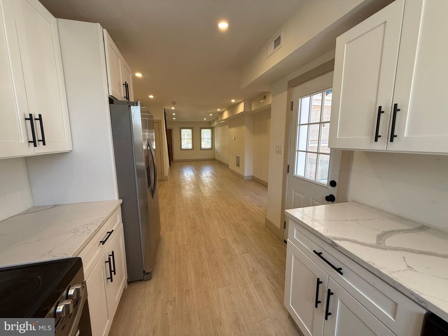 Fully renovated and move-in ready, this stunning Baltimore townhouse blends modern upgrades with functional living space. Featuring 3 spacious bedrooms and 2 full bathrooms, this home offers an open-concept main level with luxury flooring, recessed lighting, and abundant natural light throughout.

The updated kitchen showcases white shaker cabinetry, quartz countertops, stainless steel appliances, and sleek black hardware, creating a clean and contemporary feel. Upstairs, enjoy generously sized bedrooms with ample closet space and a beautifully updated full bath.

The fully finished lower level provides additional living space—perfect for a family room, home office, or guest area—plus a second full bathroom for added convenience.

Step outside to a private rear deck and parking pad, ideal for entertaining or everyday ease. Additional highlights include central HVAC, modern fixtures, and in-unit washer and dryer.

Conveniently located near major commuter routes, shopping, and local amenities—this is a perfect opportunity for homeowners or investors alike.