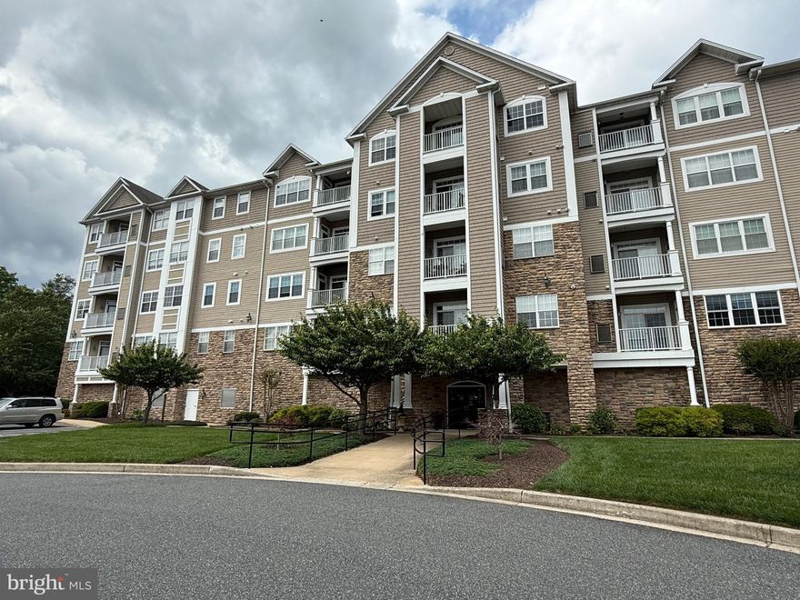 Welcome to the highly sought-after Overlook at Macphail Woods where this stunning 2nd floor condo with GARAGE and STORAGE AREA is located in a private and serene 55+ community surrounded by wooded landscaping and scenic views. Built in 2007, this unit boasts two bedrooms and two full baths, perfect for comfortable and easy living. Enjoy over 1,390 square feet of living space, all on a single level.
As you enter the building, you'll notice the covered entry with an electronic security feature for added peace of mind. The building also features an indoor sprinkler system and two elevators for convenience. Plus, you'll have access to the underground covered parking garage, which includes a reserved parking space (#18) and additional storage. Inside the condo, you'll be impressed by the open floor plan, 9-foot ceilings, crown molding, and ceiling fans. The outdoor patio is accessible from the living room and the primary bedroom, providing a great space to relax and take in the beautiful surroundings. The spacious kitchen is a dream, with granite countertops, 42-inch cabinets, all black appliances, and plenty of counterspace perfect for meal prep or casual dining.  Ample cabinetry ensures that there’s more than enough storage space for all your kitchen essentials. The living room and dining room offer a perfect space for relaxation and entertaining, featuring large windows that let in plenty of natural light. From here, step outside onto the patio to get a breath of fresh air. The primary bedroom features a walk-in closet, along with a linen closet in the en-suite. The primary bathroom is equipped with grab bars, a built-in seat in the shower, ceramic flooring, and a double vanity sink. The second bedroom comes with a corresponding second full bath and a shower/tub combination. This unit also includes tucked-away laundry room/utility full size washer and dryer, water heater, HVAC system and extra storage space. In addition to the unit's amenities, you'll have access to the community room on the second floor, which includes a gym, living room, and dining room. Outdoors, there are plenty of natural open spaces to enjoy the fresh air. Plus, the backup generator ensures all common area amenities are always available. Lastly, two pets are allowed in this community as long as they are under 35lbs, so bring your furry friends along! Don't miss your chance to live in this beautiful and comfortable condo unit. Condominium Fees include all water, sewer, and trash services, ensuring convenience and peace of mind. Macphail Woods Crossing is located just minutes from downtown Bel Air, this condo offers the best of both worlds – peaceful, nature-inspired living with easy access to shopping, dining, and entertainment. Don’t miss your opportunity to make this extraordinary condo yours. Schedule your private tour today and experience why this is condo living at its finest!
