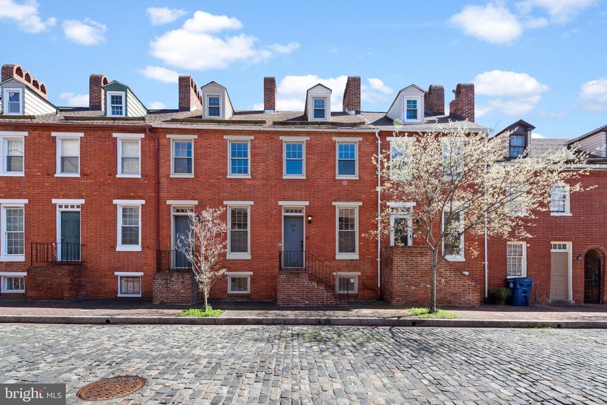 Old Town, tucked away in the middle of Baltimore’s best, this newly sought-after neighborhood is home to Baltimore’s original “Dollar House”. Purchase a piece of history on this brick laden street just seconds away from downtown, Hopkins, Mount Vernon and more! One of the coolest features of this all-brick home is that it’s actually two houses put together to create one masterpiece! Once inside, the details are incredible with the beautiful floor-to-ceiling windows, 4 decorative fireplaces, exposed brick and unique floorplan. Additionally there is a completely bricked in patio with gorgeous hardscape and a garage! Upstairs there is an expansive primary suite with two fireplaces (non-functioning), closets and a double room. The bathroom is totally custom with a standing shower with multiple jets and free-standing tub complete with a double vanity. A bonus feature for level 3 is the fact that there is separate space for an office! The top floor is equally massive with two sections and closet space. The basement is also fully finished with a separate room and full bathroom. The amount of natural light in this house is simply breathtaking. The entire house has been freshly painted and new flooring has been installed. The house is ready for new owners who will appreciate the attention to details and the amazing location. See for yourself and don’t miss out. Call for a private tour today!