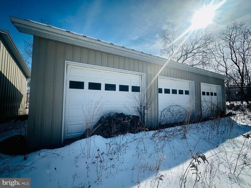 Perched at the top of the street with scenic views overlooking the Cumberland Airport and the City of Cumberland, this property offers two oversized garage buildings ready for their next owner. The garages include a two-bay unit and a three-bay unit, both built by Featherbuilt and previously used for storage.

The property is equipped with 200-amp electric service and an RV hookup already in place. Public water and sewer are available at the property, offering future expansion possibilities if desired.

With ample space, the lot also provides the opportunity to add a tiny home or trailer, making this a versatile investment for storage, hobby use, or potential residential setup.