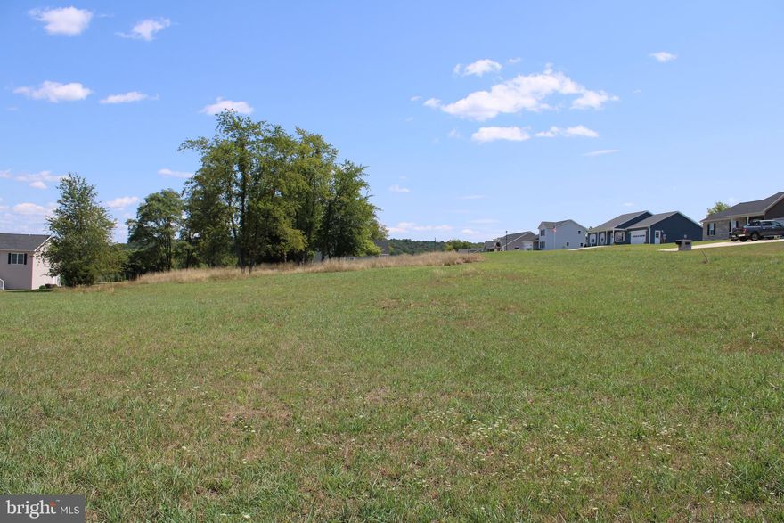 Located in the highly sought-after Harvest Hills Subdivision, this prime corner lot is one of the last available, offering 0.66 acres ready for your forever home. With all public utilities in place, this property combines convenience with potential. Ideally located near schools, the hospital, and local shopping, it provides easy access to everything Hampshire County has to offer. Plus, with a short 45-minute commute to Winchester, VA, this lot is an opportunity you won't want to miss.