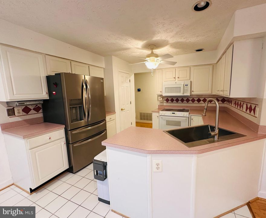 Lovely main level condo in sought after Spring Ridge. 2 bedrooms and 2 full bathrooms. Primary Bedroom with walk in closet. Primary bath has heated floor . Large livingroom with television mounted on the wall. New blinds, newer hvac system and hot water heater, new garbage disposal, refrigerator and blinds. Tile floors in both bathrooms and kitchen.  Bamboo floors in livingroom. Private deck with views. Neighborhood has tons to offer. 3 pools, hiking trails, tennis courts, tot lots, sport fields and community center. Great Location! Call today for a tour.