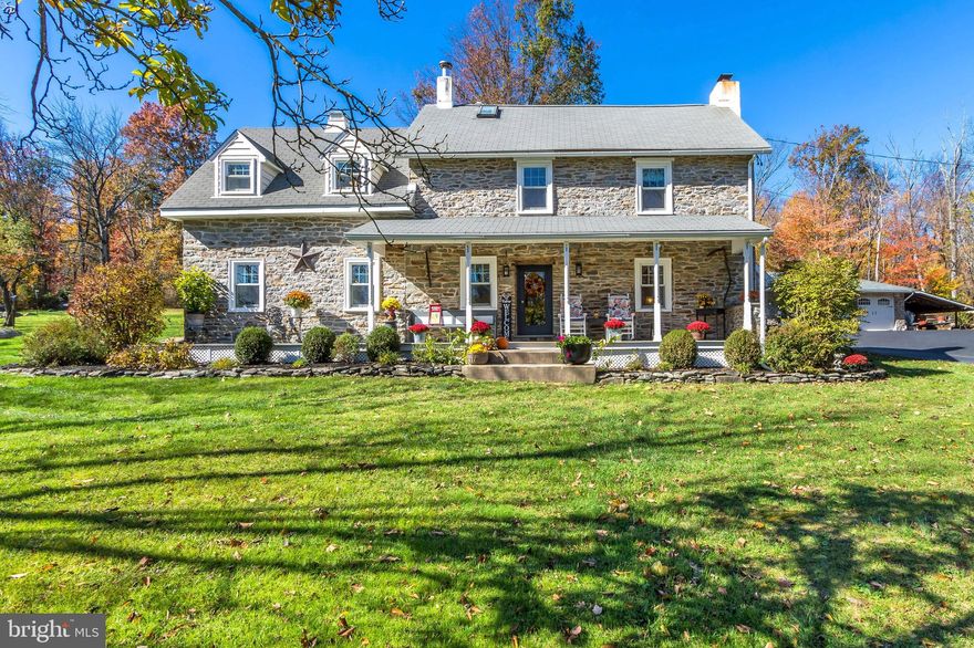 Along a quiet country road just a stones throw from the thousands of acres that is Lake Nockamixon State Park is Boulder Ridge - your own private two parcel, 23+ acre haven. The lot is simply beautiful. Partly opened and partly wooded, you can walk through the countryside listening only to the whisper of the trees. There are large clearings for fun overnight camping, games or ATVs and still plenty of woodland trails with not a neighbor in sight. Down a long treelined driveway is a gracious farmhouse with two separate detached garages. The original two story section of the home dates back to the late 1700s, and another family added on a second portion in the 1890s. Later additions and changes were made but all were in keeping with the best of American Farmhouse design. The farmhouse features a wonderful wide rocking chair front porch and a sunny side porch– the best places to relax and watch the little creatures play. Deer, squirrels, the occasional wild mink or your own little creatures have this vast natural playground to run around and enjoy. Inside you can feel the steadiness of the generations that were provided safety and comfort within this home’s thick stone walls. The front door opens into the living room with exposed beams, beautiful hardwood floors and a walk-in fireplace with muscular lintel and cast iron woodstove. This genial room, along with the dining room and bedrooms directly above, is the original section of the home. If walls could talk, they would tell you of the hundreds or years of holidays enjoyed in these more formal rooms. We pass the laundry and powder rooms on the way to the remodeled kitchen and breakfast room. Such a bright and sunny space! Open and airy, the modern kitchen is center of this home with beautiful granite countertops, top line appliances and expansive cabinetry. It is open to the spacious new sunroom with walls of windows bringing four seasons of color inside. You can enjoy watching the changing view in comfort since this room features radiant heat. The entrance to the attached two car oversized garage with second floor storage is through this room. A large picture window separates the sunroom from the family room with a second fireplace and woodstove. This is the coziest of places to cuddle up and watch the ballgame. A two story foyer with muscular staircase and wrought iron fixture leads to the second floor. Of particular note are the lighting fixtures in this home – more than thirty gorgeous wall scones grace every room. The best feature of the primary bedroom suite is the view. A huge picture window topped with half-moon window has been placed directly across the room from the bed wall. Imagine being snuggled under quilts with your morning coffee watching the snowfall. A glistening primary bath with jetted tub, glass enclosed shower and walk in closet complete the suite. In addition there is a door to the second floor garage storage room. If more bedroom space is needed, an office or sitting room, here is the best opportunity for placement. Two additional spacious bedrooms, both with excellent closet space share a beautifully appointed hall bath. The copious amount of closet space is surprising in a home of this vintage! On the third floor is the sweetest of bedroom suites. Entering through the sitting room you find a lovely full bath and multiple closets. Tucked into the eaves, this is the perfect guest suite or a great set of rooms for extended or blended family. Back outside, the three car oversized garage is wonderful for contractors and hobbyists. A third, one car detached garage, has been fortified to house the heaviest of equipment. Boulder Ridge is a marvelous opportunity to become the next stewards of this beautiful property, enjoying its rich heritage and modern touches, while tending it for the generations to come.