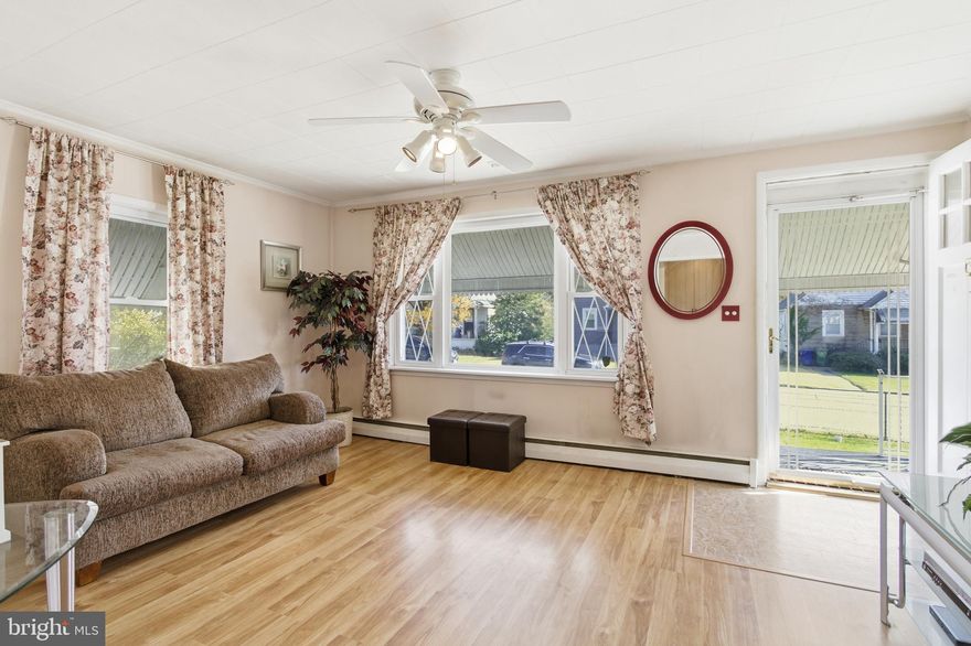 Welcome to this charming detached home, full of potential and ready for your finishing touches! The main level features LVP flooring, a spacious living room, an eat-in kitchen with ample cabinet and prep space, a step-down dining/sitting area, two bedrooms, and a full bath. The fully finished lower level offers flexible space that could function as a rec room, home gym, office, or be converted into 1–2 additional bedrooms. A half bath, utility room, and extra storage complete this level. Seller is willing to convert to a 3-bedroom with an acceptable offer. Relax year-round in the all-season sunroom, or enjoy the outdoors on the covered patio overlooking the spacious backyard. A shed and garage provide great storage or workshop space, and the private driveway offers easy parking. Conveniently located near Walther Avenue, Belair Road, and Harford Road, this home provides quick access to shopping, dining, and major commuter routes. Bring your vision and make this house your home—schedule your showing today!