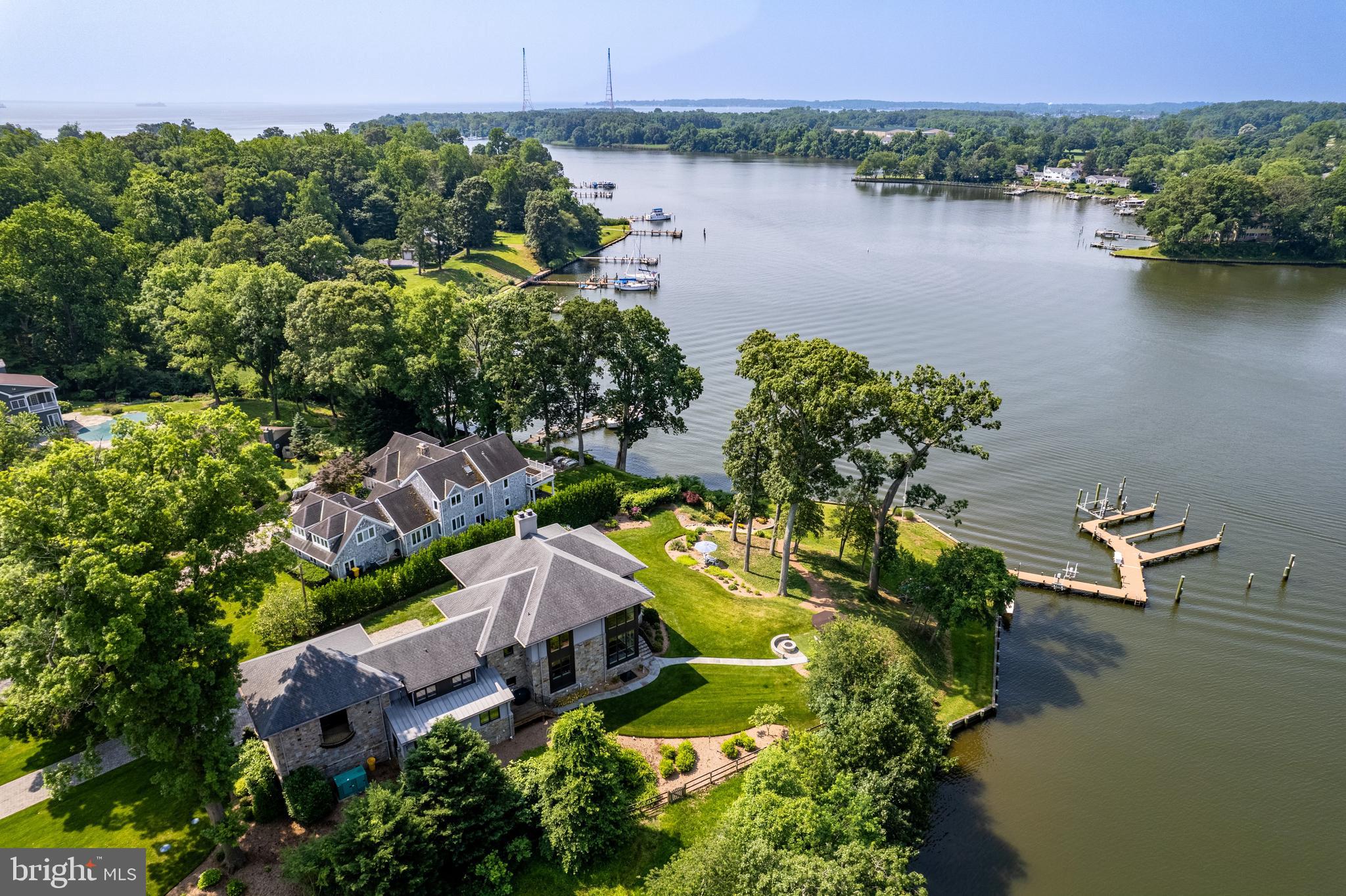 A Rare Opportunity on Milvale Road and Mill Creek.
This exceptional waterfront property, crafted by renowned builder Lynbrook Homes and thoughtfully designed by architect Vince Green, offers a rare blend of luxury and serenity. The open-concept floor plan is designed to maximize the sweeping, panoramic views of Mill Creek, with western exposure providing breathtaking sunsets year-round.
Spanning three beautifully finished levels, the home is connected by an elevator and showcases designer touches throughout. The gourmet kitchen is a chef’s dream—outfitted with top-tier appliances and ideal for both grand entertaining and intimate gatherings.
The luxurious primary suite is a private retreat, featuring a spa-like bath with a soaking tub, oversized shower, and dual walk-in closets.
Outside, the 250-foot shoreline is secured by a new seawall (2021), while the private pier is a true highlight for boaters: four slips, a 12,000-pound boat lift, three jet ski lifts, and an impressive 8 feet of mean low water depth. Other important features include, Geothermal heating and cooling, propane fireplaces, state of the art water treatment system, 50 KW generator and additional lot across the street.
More than a home, this is a private resort-style sanctuary—designed for those who demand the very best in waterfront living.