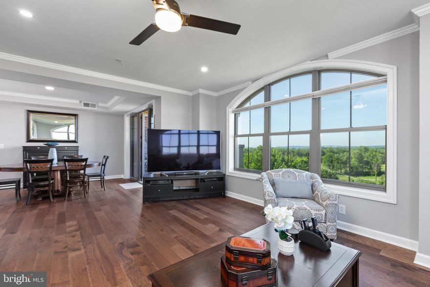 Enjoy magnificent views from this gorgeous light filled top floor unit in the highly desired Harborview in Belmont Bay.  With upgrades galore this penthouse unit will not disappoint.  Beautifully updated bathrooms to include reconfigured shower in primary bath and added pocket door for toilet room privacy, illuminated mirrors, tile wall and flooring, pebble shower flooring, frameless glass shower, waterfall spout and rainfall shower head.  All new hardwood flooring covers this almost 1,900 sq ft luxury property, completely updated all electrical, crown molding, chair rails, wainscot design details, and more.  Kitchen features granite countertops, stainless steel appliances, and wine fridge.   From your balcony you can enjoy bird watching, breathtaking sunsets, and ultimate peace and serenity.  Belmont Bay offers an active social committee with concerts and annual festivities, walking trails, simple access to boat memberships, and retail at the marina.  Don't miss the opportunity to call this community home with  convenient  proximity to the VRE, Rt. 1 and I-95.