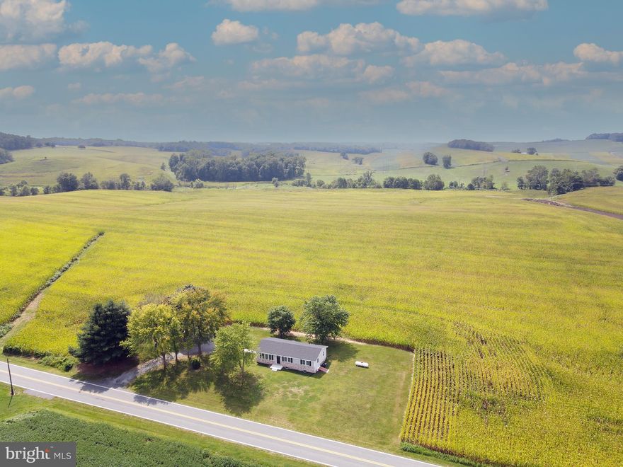 Welcome to 8318 Woodville Rd!  This cozy rancher is nicely updated and sits on about half an acre and is surrounded by farmland in a beautiful country setting. Main level features three bedrooms; a full bath with tub shower and large vanity; a living room with lovely views of the front yard; and the kitchen and dining room.  Convenient exterior access to the driveway through the kitchen and off the dining room is access to the backyard patio. Full basement has the laundry with a full sized washer & dryer, storage area and walk up to the side yard. Enjoy modern amenities of central air, propane forced air for heat, stylish vinyl plank floors throughout and updated bath.  Large driveway for parking. Small dog okay, no cats. All inquiries go to property manager.