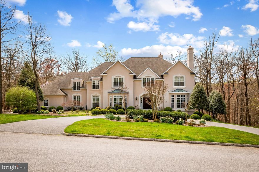 Indulge in the luxurious craftsmanship of this exquisite home, crafted by acclaimed builder Bob Pollack, renowned for using the finest materials and a meticulous attention to detail. Perfectly situated in the highly desirable community of Laurelford Court.  This home is surrounded by custom luxury properties with generous lots, open spaces, and superior features. The house radiates English Country charm with a welcoming entrance foyer and an elegant curved staircase that greets you upon arrival. The expansive open rooms are filled with natural light that pours in through oversized windows, highlighting the high ceilings, back staircase, elevator, and wonderfully finished hardwood floors. The grand country kitchen, complete with island, quartz countertops, stainless steel appliances, and ample soft-white cabinetry, leading to a sun-filled breakfast room with a curved wall of Palladian windows and soaring ceiling height.  The breakfast room leads to the family room with fireplace and French doors that open onto an expansive deck and covered porch, creating the perfect indoor-outdoor living space. The upper level boasts three large bedroom suites with generous walk-in closets. The fourth bedroom is the primary suite, complete with a private study, a dressing room with two walk-in closets, and a spa-like bath with separate vanities, making it the perfect retreat. The finished light-filled lower level features two spacious rooms, a wet bar, full bath, an exercise/wine/study area, walk-out to patio,  making it the ideal space for entertaining guests.  Located in the Falls Road Corridor, this home offers convenient access to excellent public and private schools, sophisticated shopping, restaurants, fitness centers, salons. The best of county living.  Just minutes from I83, & 695 Beltway.