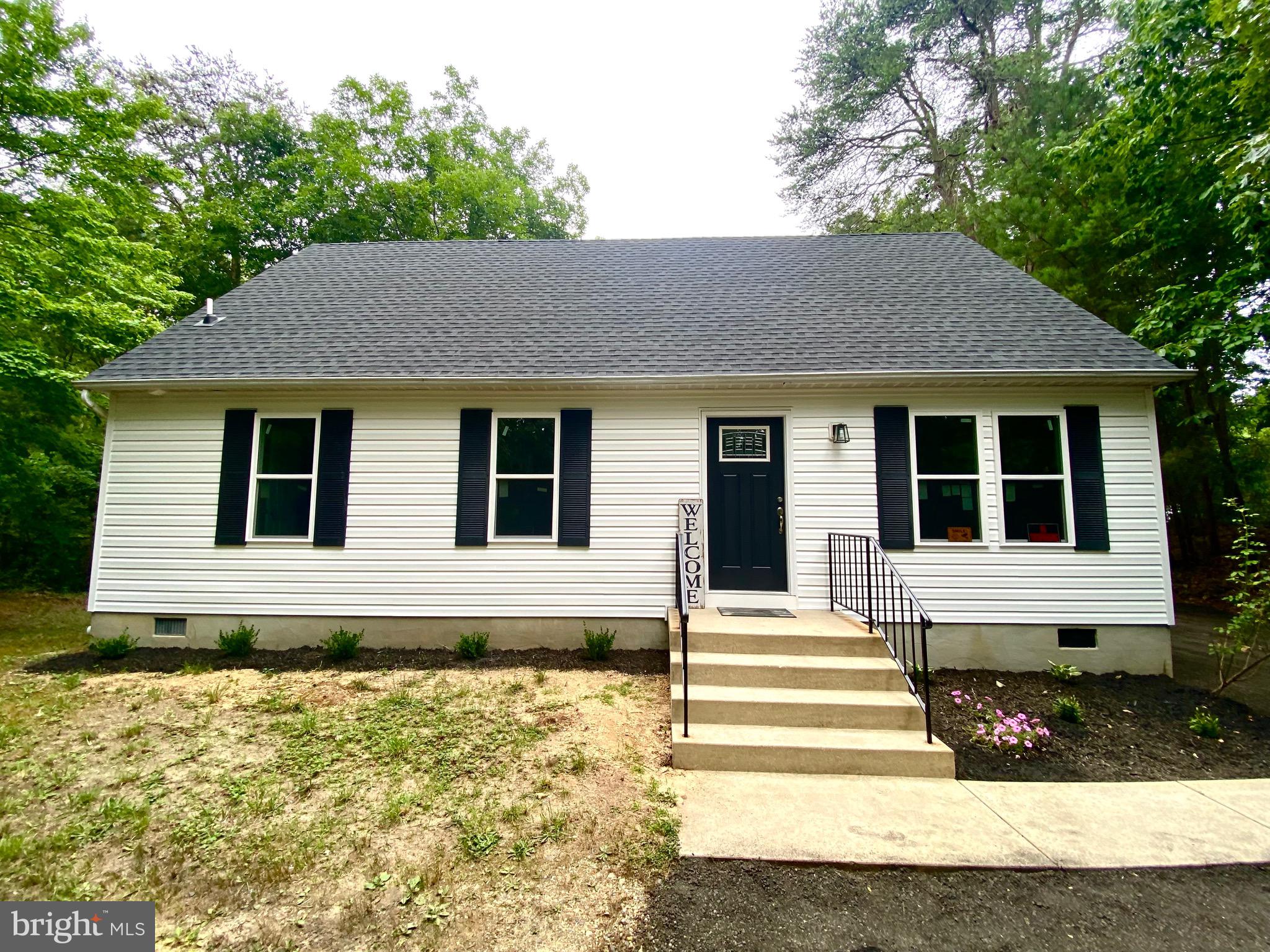 Don't wait a year for a new build! This completely remodeled 4 bedroom with 2 bathrooms home was permitted and inspected per Calvert County standards! BRAND NEW Architectual shingles, BRAND NEW windows, BRAND NEW siding, BRAND NEW HVAC, BRAND NEW carpet, luxury vinyl planks, and ceramic tile. This gorgeous kitchen has a subway tile backsplash, granite countertop, white cabinets, black stainless steel appliances and black accent fixtures! The first floor primary bedroom has an attached personal bathroom with a huge custom tiled shower, black accent fixtures, and a pocket door leading into a walk-in closet. The two upstairs bedrooms are HUGE! Don't need 4 bedrooms?? Turn one HUGE room into a game room/living room and the other into an office! This home also sets back from the road on almost an acre of land with trees, a deck and a level backyard.